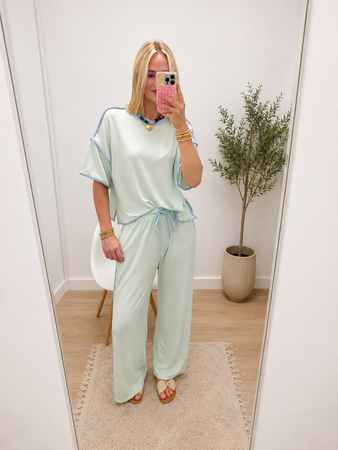 Mint green matching lounge set with short-sleeve top and wide-leg drawstring pants, blue trim detail.
