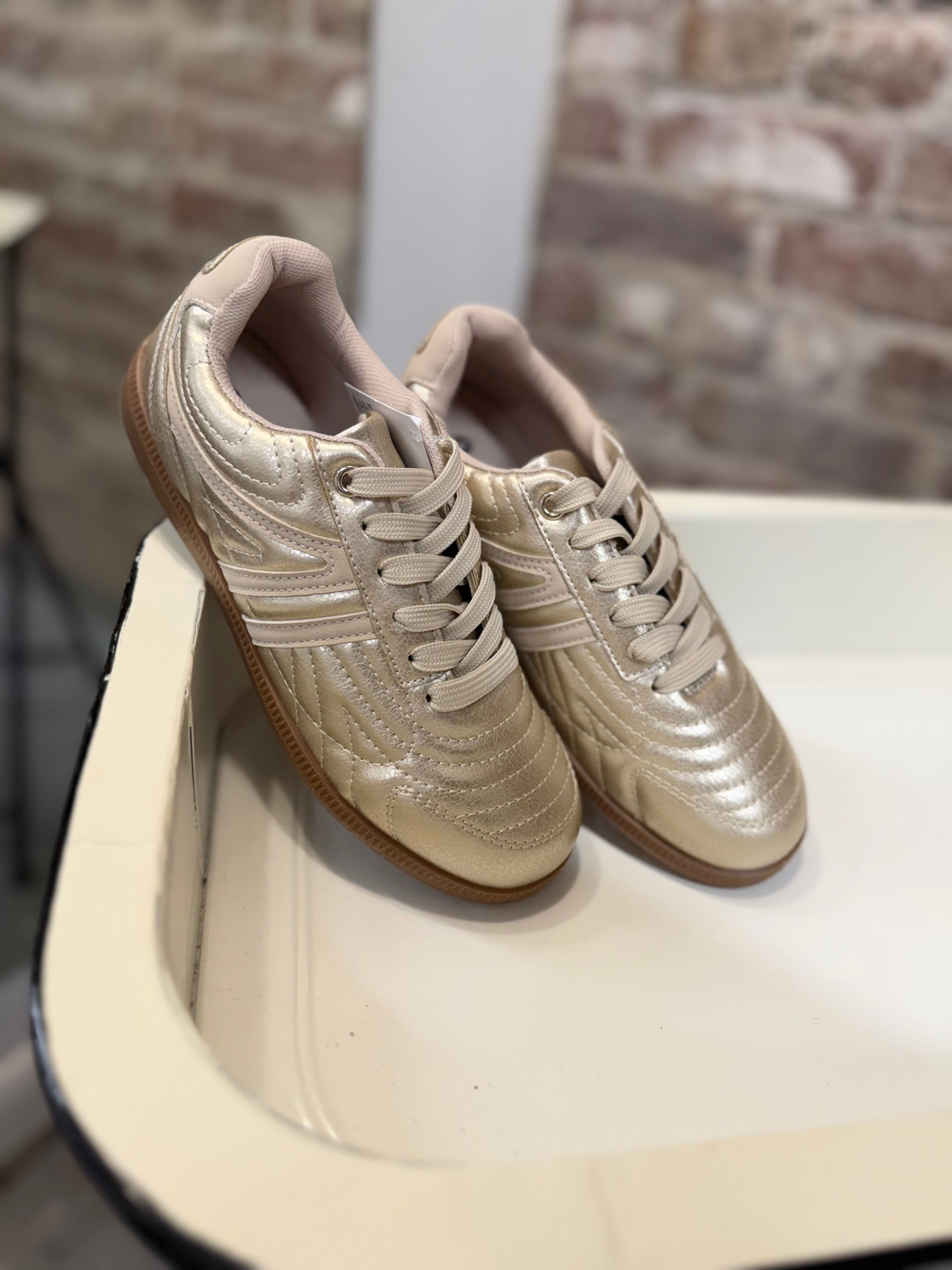 Sydney Sneaker in metallic gold with lace-up closure, quilted upper, and gum rubber sole.