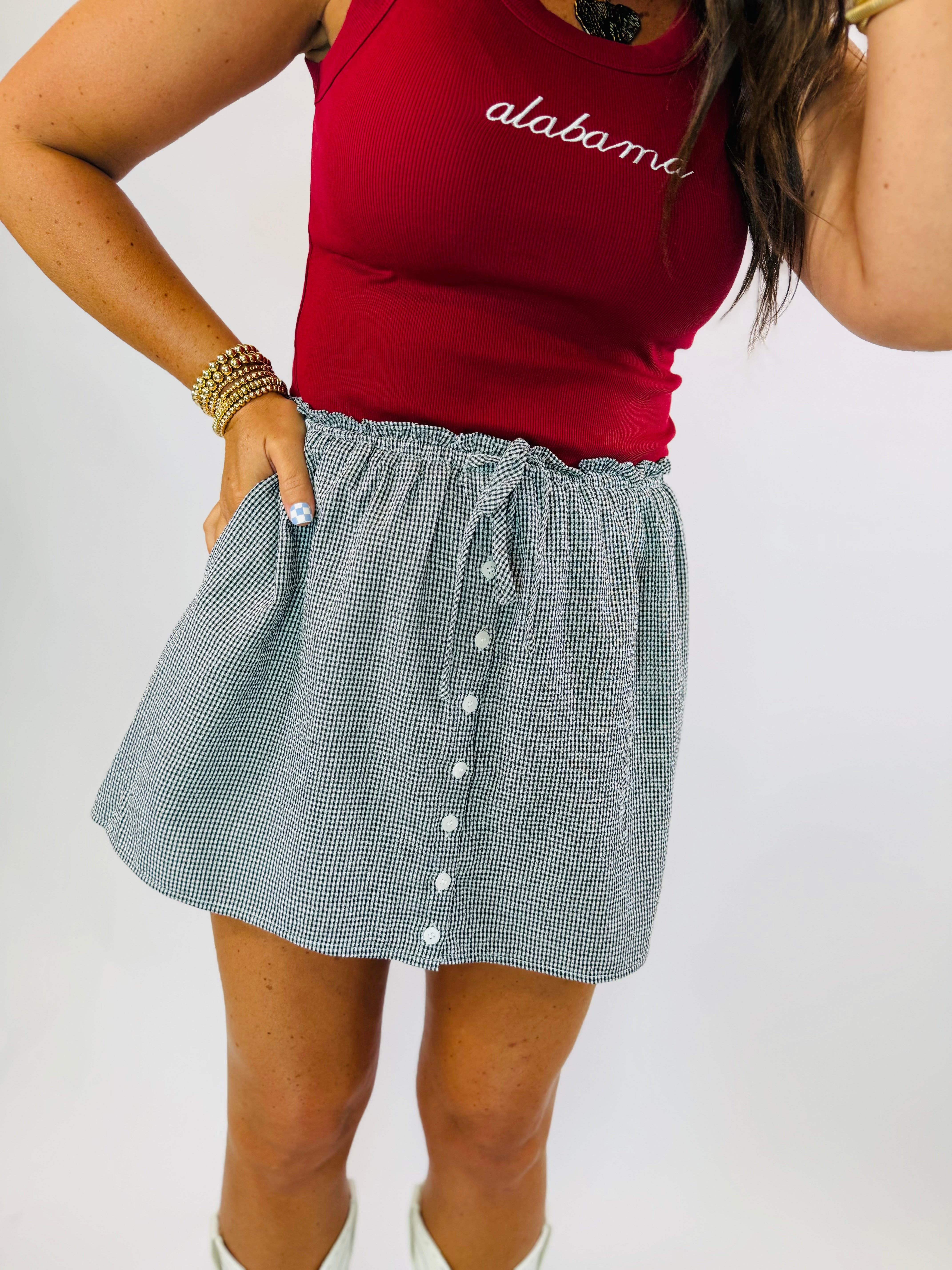 Gracie Skort in black and white gingham check pattern with button front and elastic waistband.