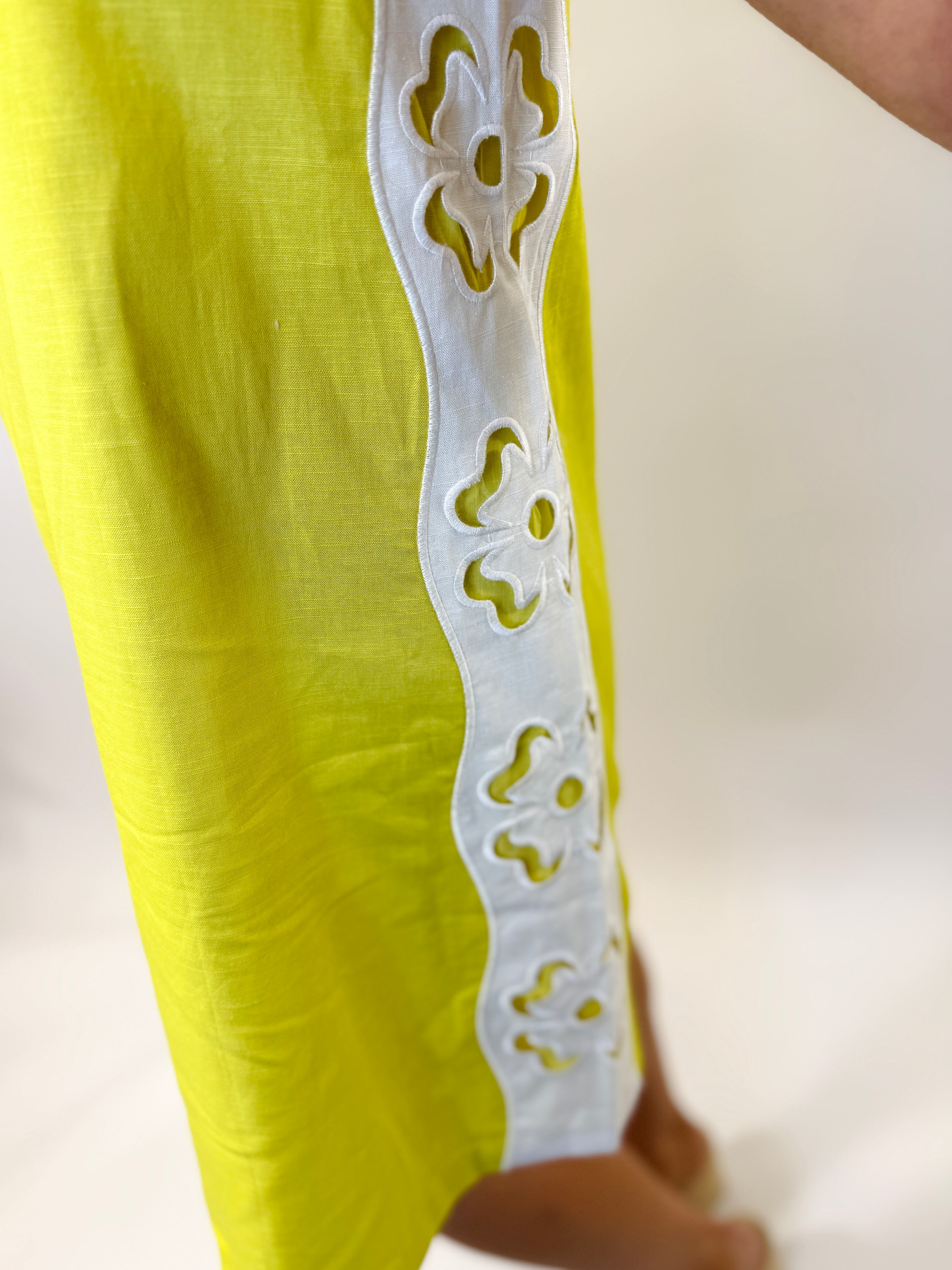 Yellow Farrah dress with white eyelet lace trim detail along the side seam