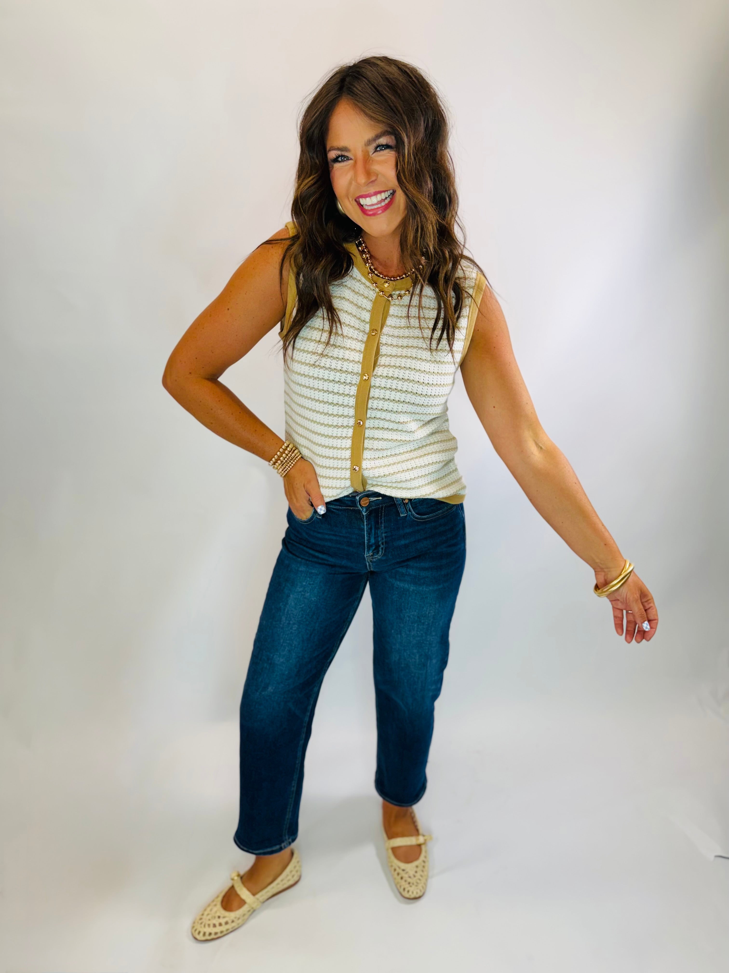 Bevin Top: cream and tan striped sleeveless knit top with gold button detail, styled with dark jeans.