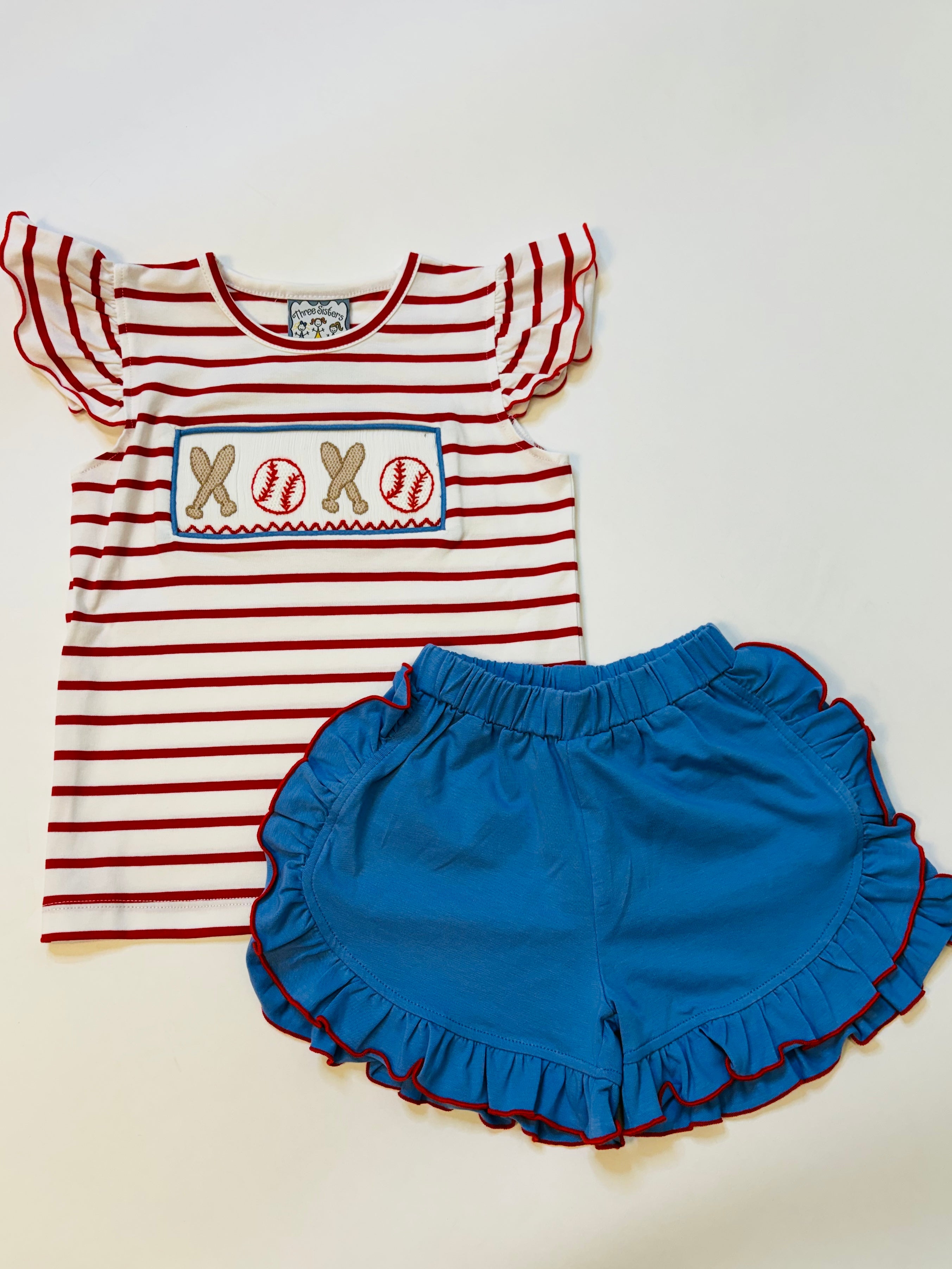 Red and white striped baseball-themed top with blue ruffled shorts, featuring embroidered "XOXO" baseball design.