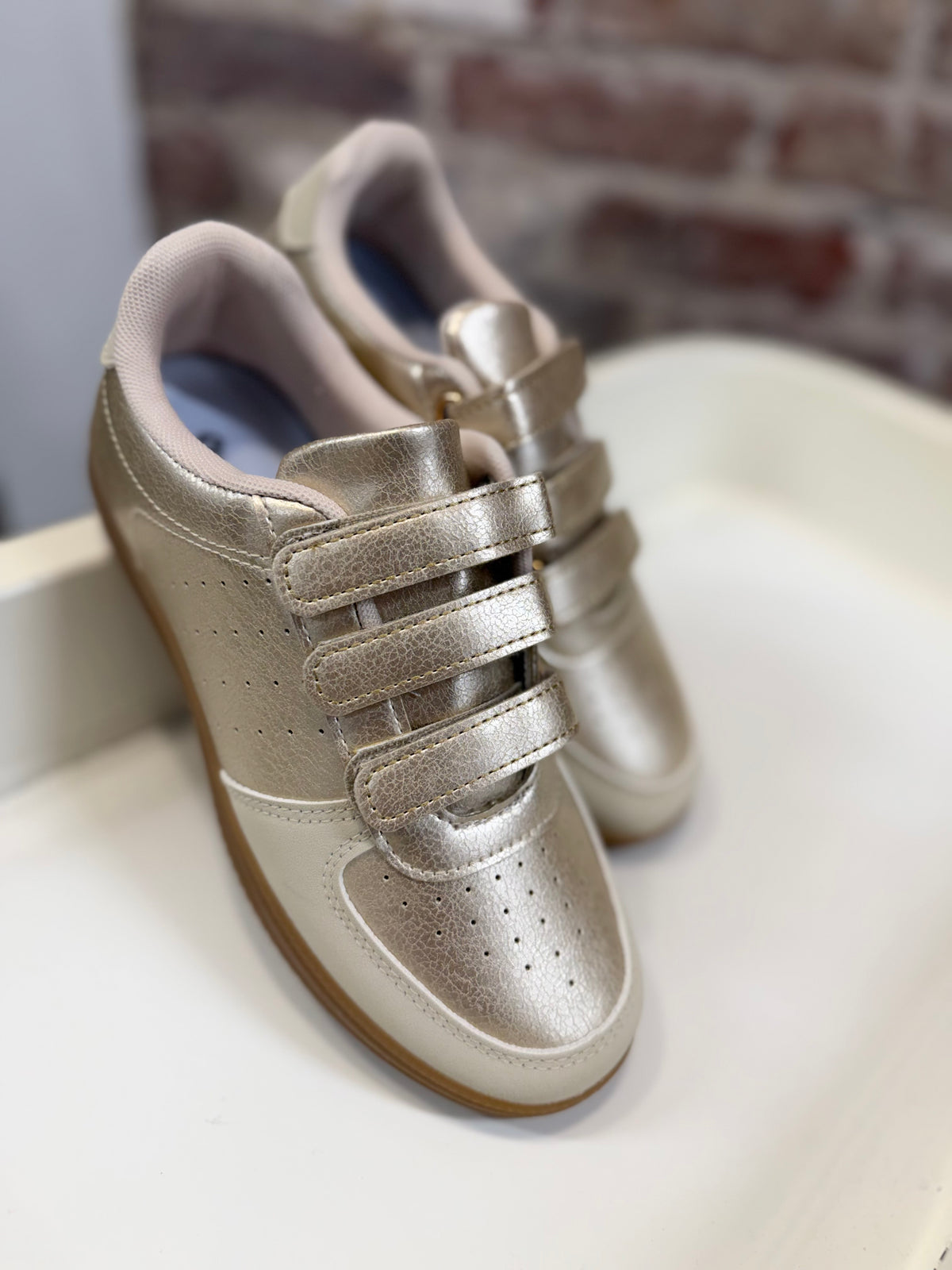 Giana Sneaker in metallic gold with triple velcro straps and gum rubber sole.