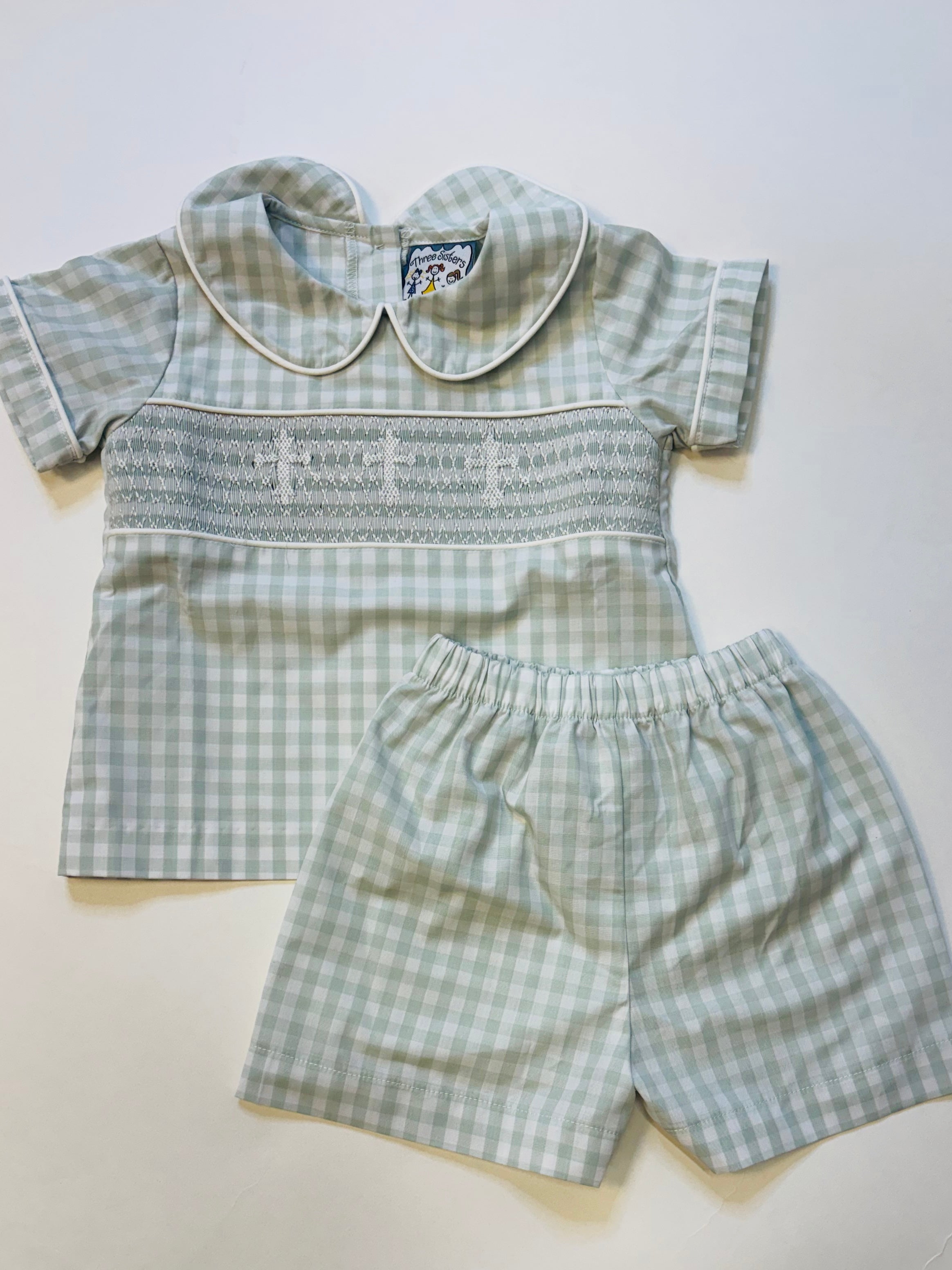 Green gingham boys short set with white Peter Pan collar and hand-smocked chest detail.