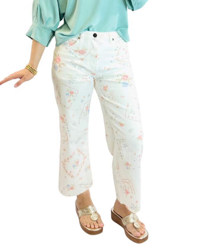 Woman wearing white floral printed cropped pants with mint green shirt and gold sandals