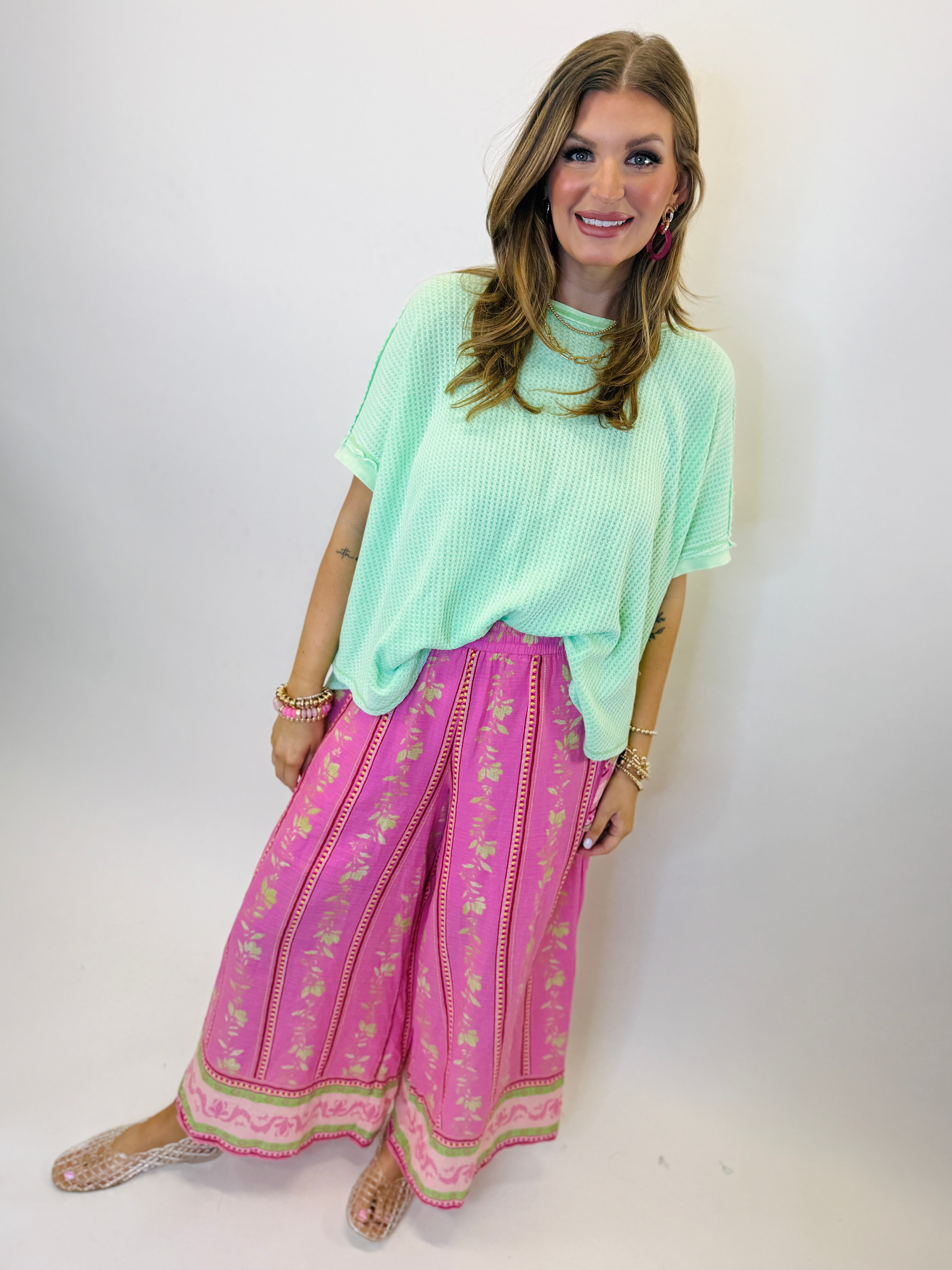 Woman wearing mint green oversized waffle knit top with short sleeves and relaxed fit