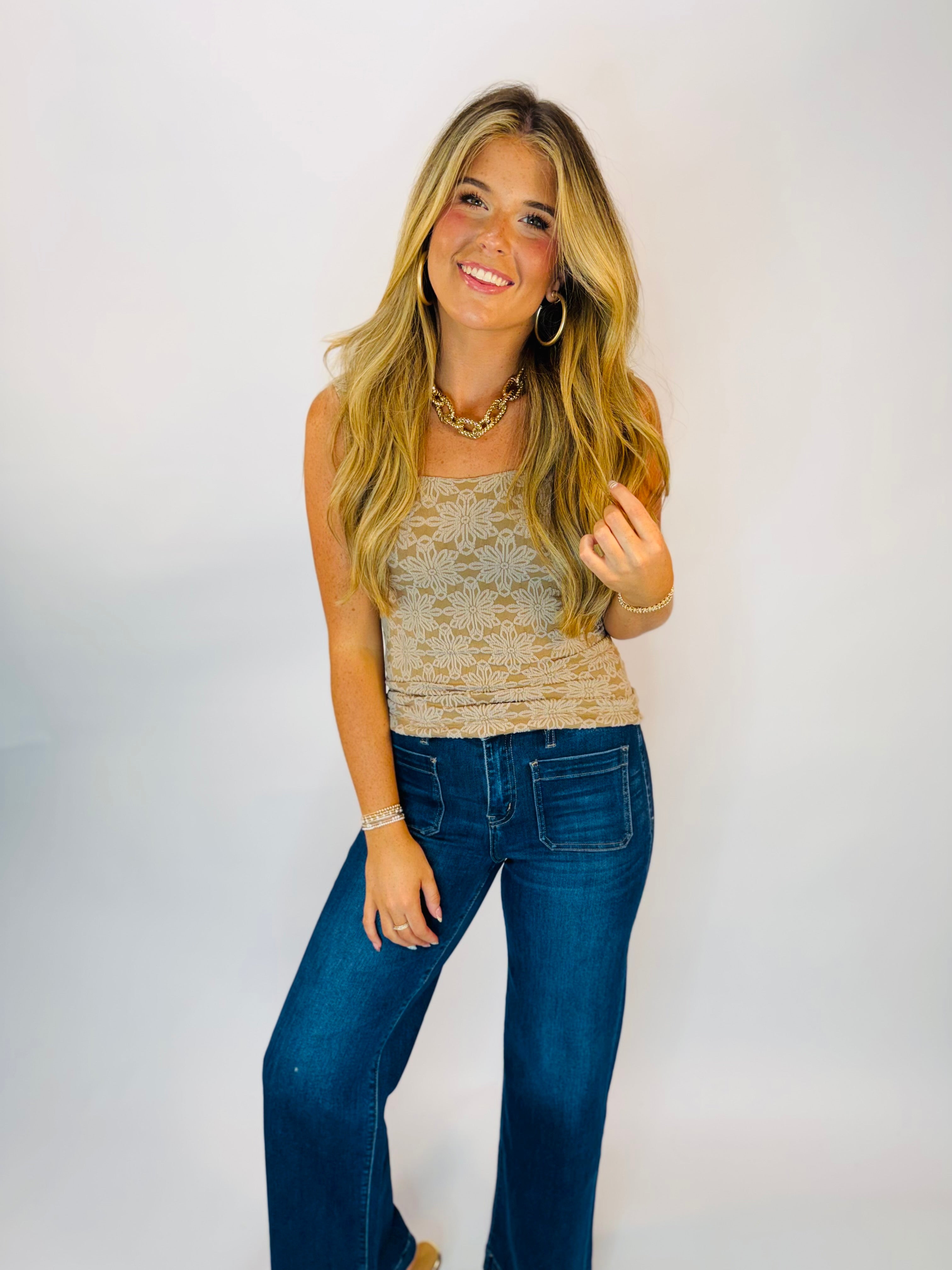 Women's tan floral lace sleeveless Hannah Tank top styled with dark flare jeans and gold jewelry.