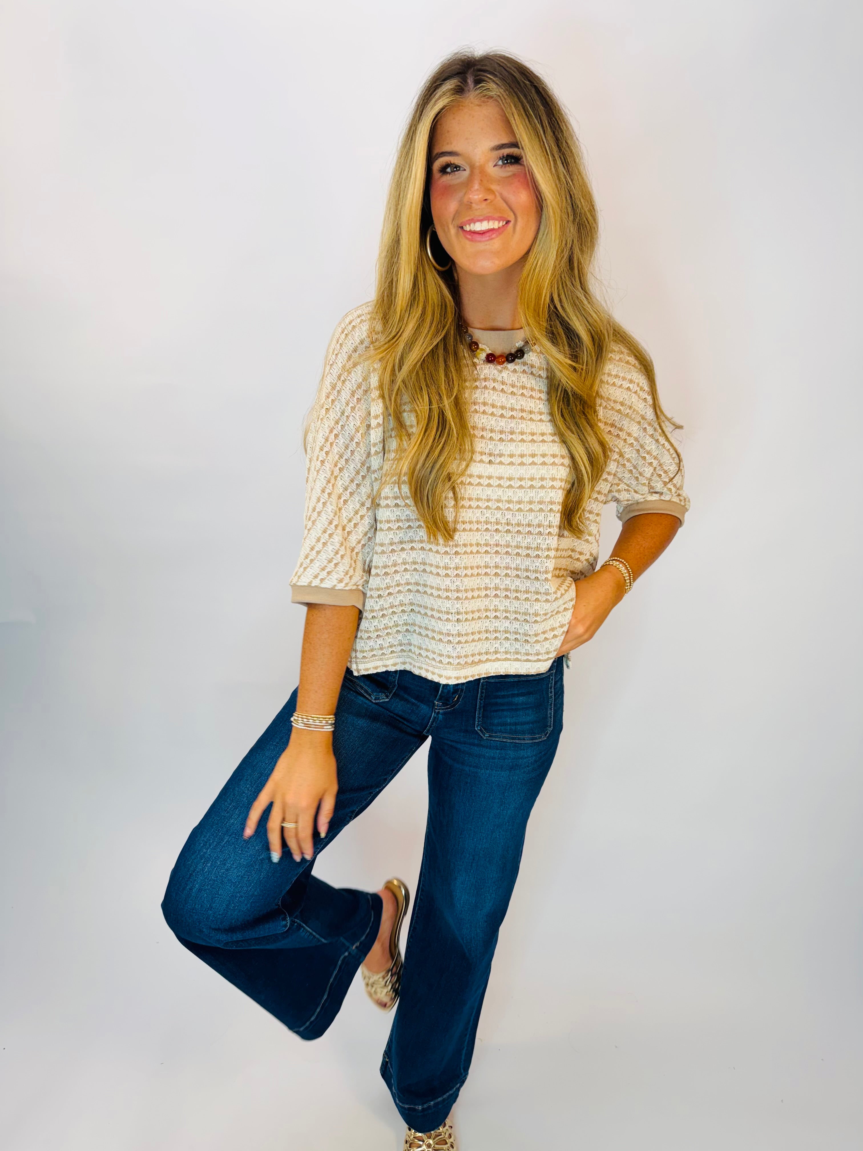Natalie Top in Mocha, a cream and tan striped knit short-sleeve top with cuffed sleeves, styled with dark wash flare jeans.