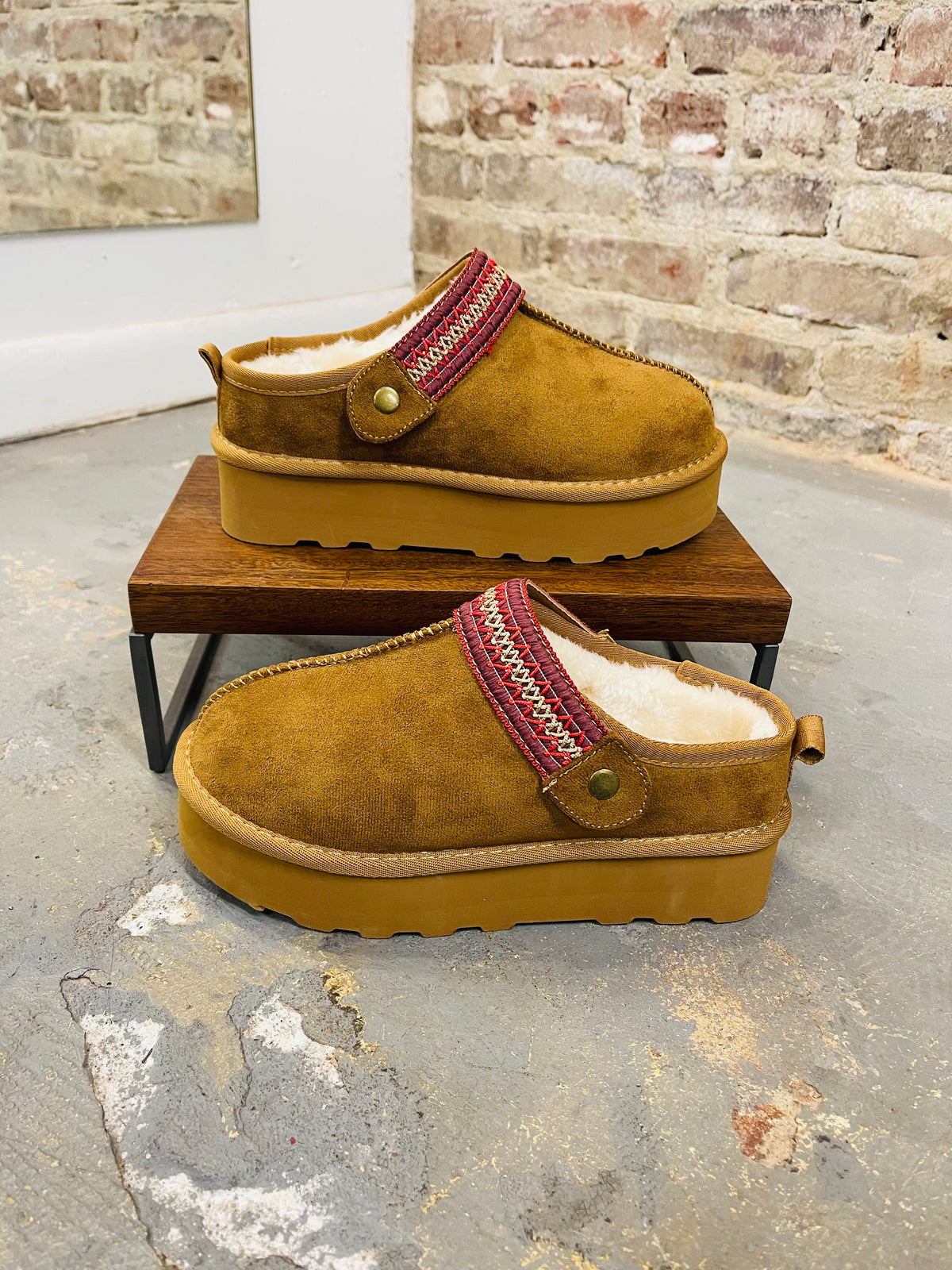 Brown suede Lily slippers with red patterned trim and yellow platform soles, lined with white fur