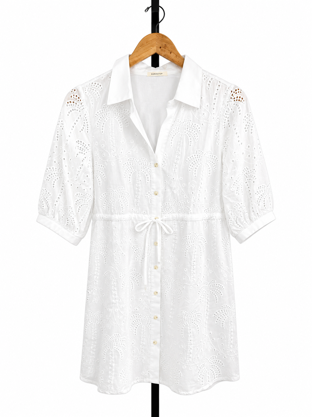 White eyelet embroidered short-sleeve shirt dress with collar, button front, and tie waist.
