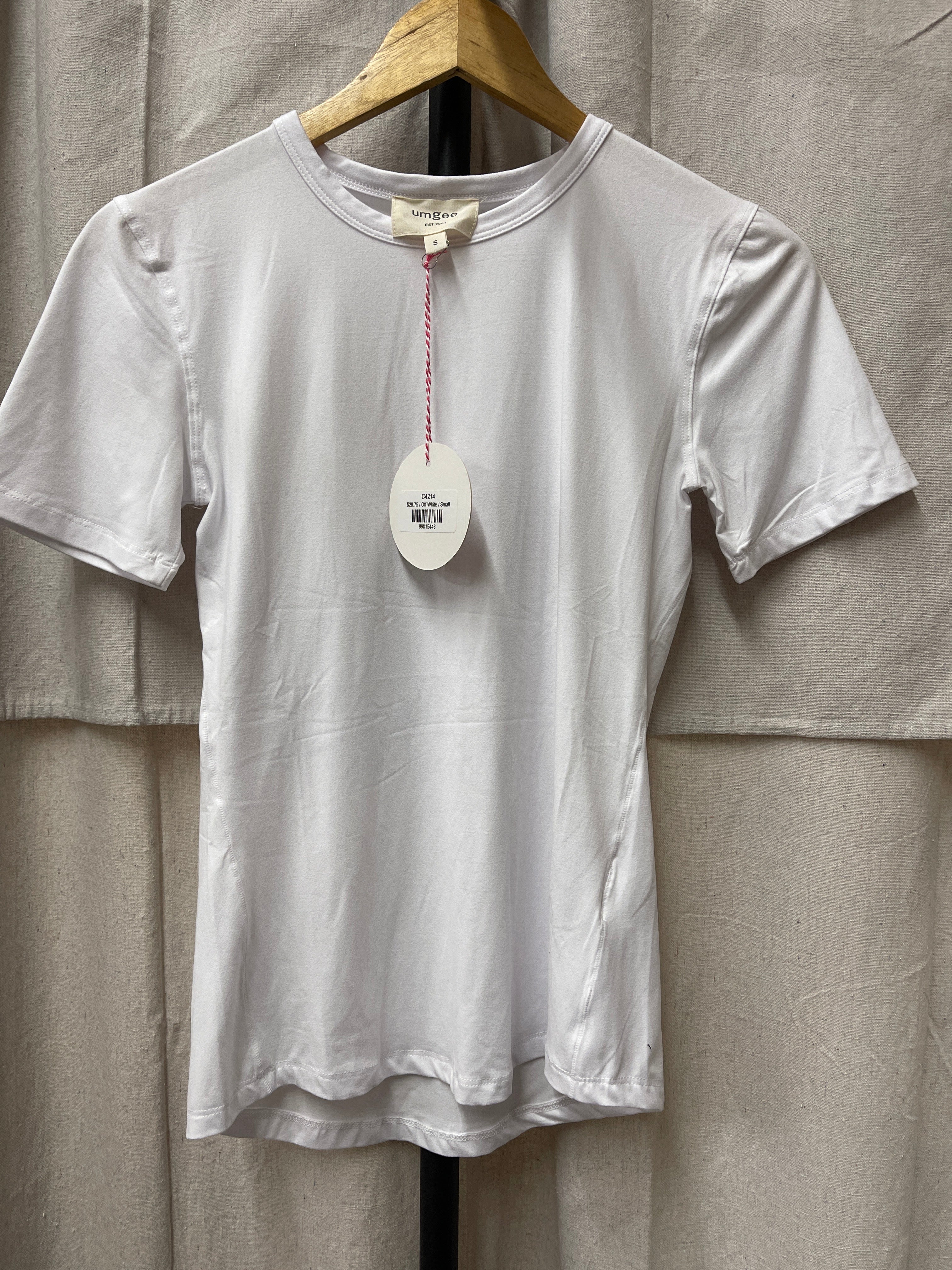 White short-sleeve Jenny top hanging on wooden hanger with price tag against neutral fabric background.