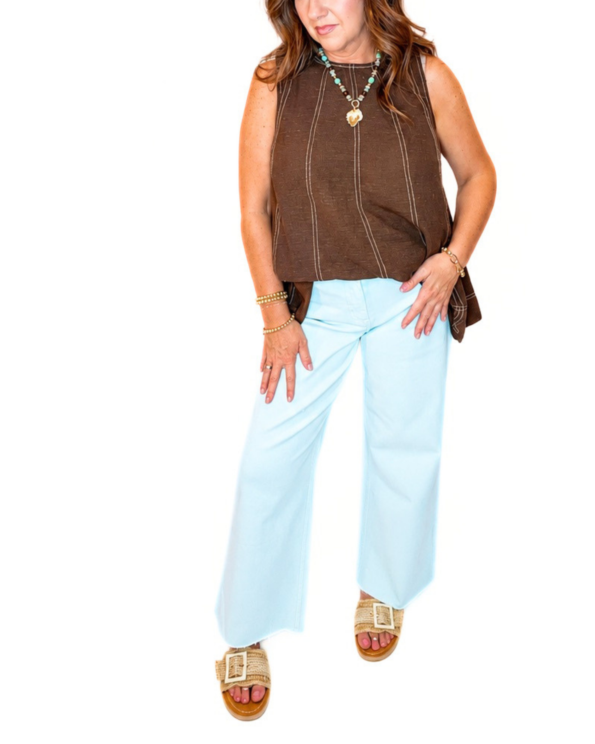 Wide-leg sky blue cropped denim pants styled with brown sleeveless top and woven sandals.