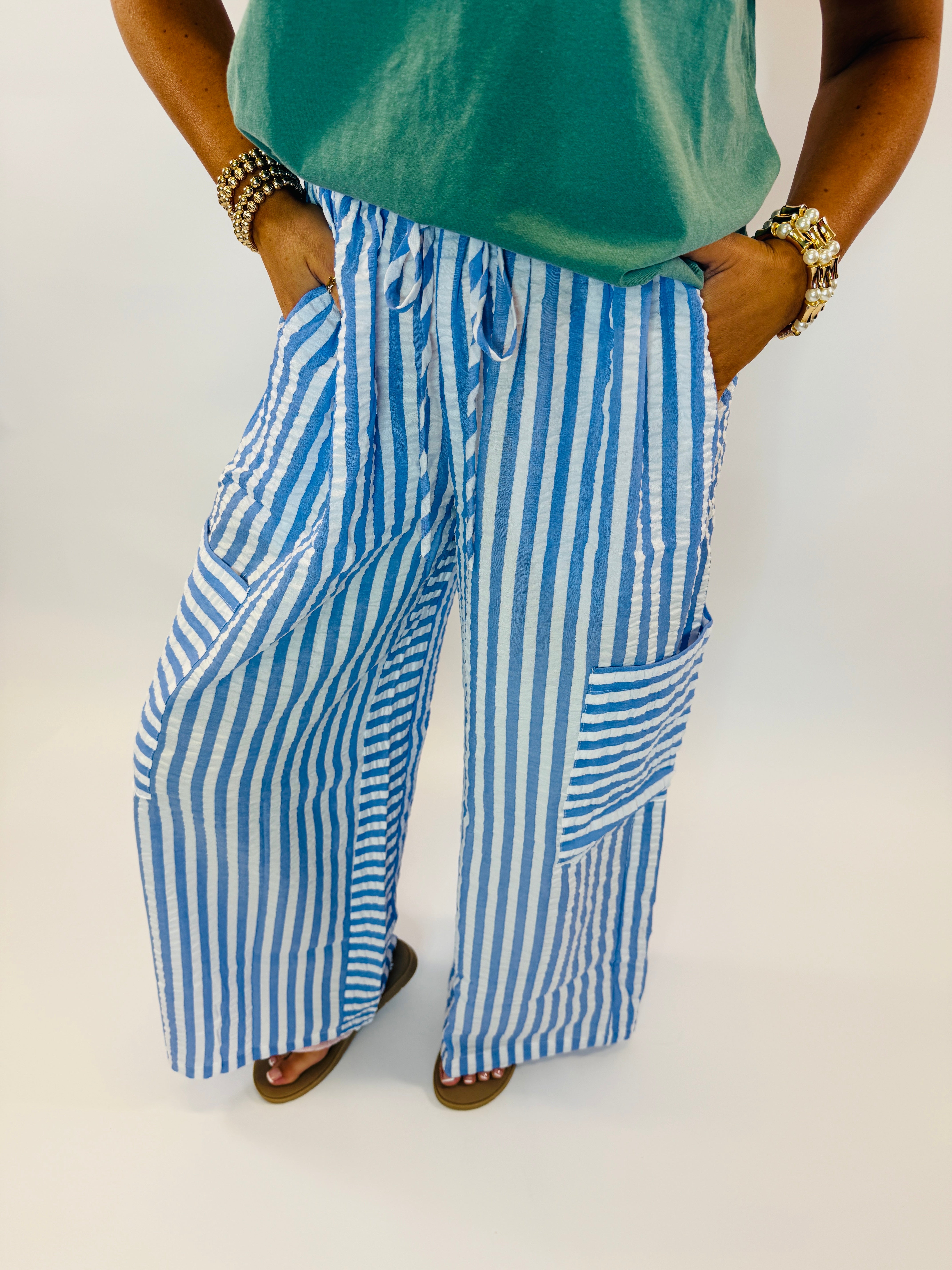 Woman wearing blue and white striped wide-leg pants with drawstring waist and front pockets