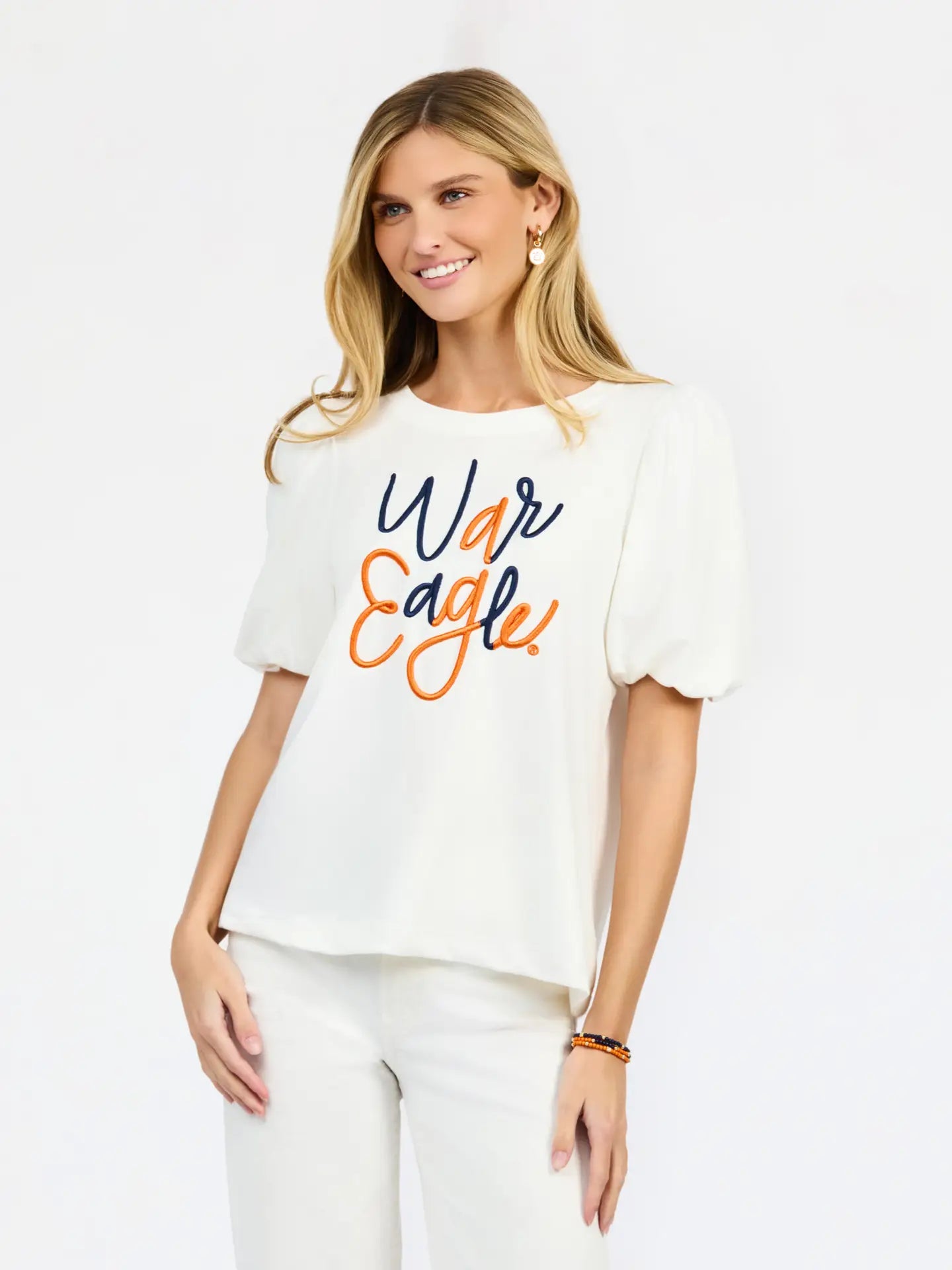 White short-sleeve puff-sleeve top with embroidered "War Eagle" script in navy and orange.