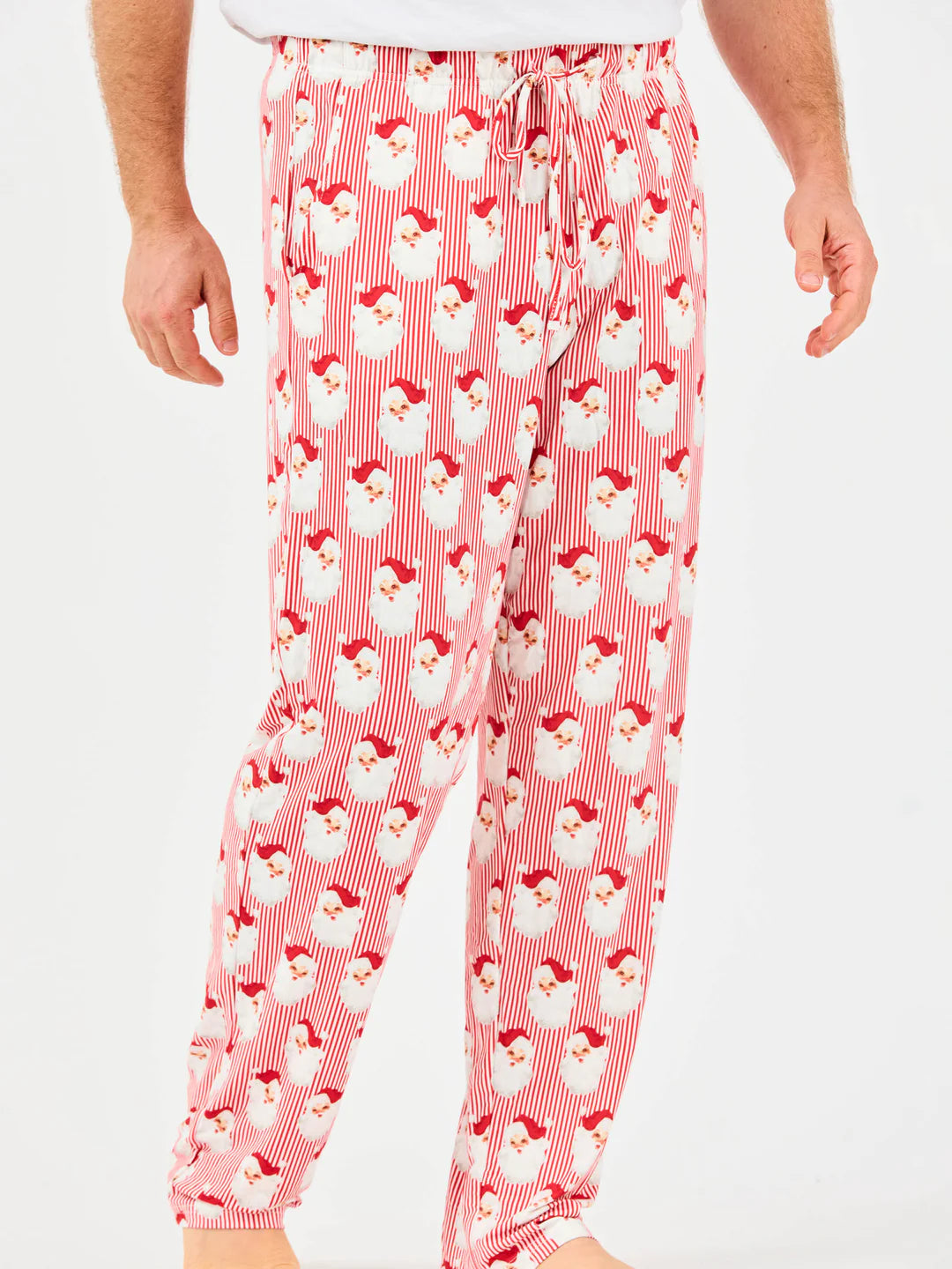 Red and white striped pajama pants with Santa Claus face pattern and drawstring waist