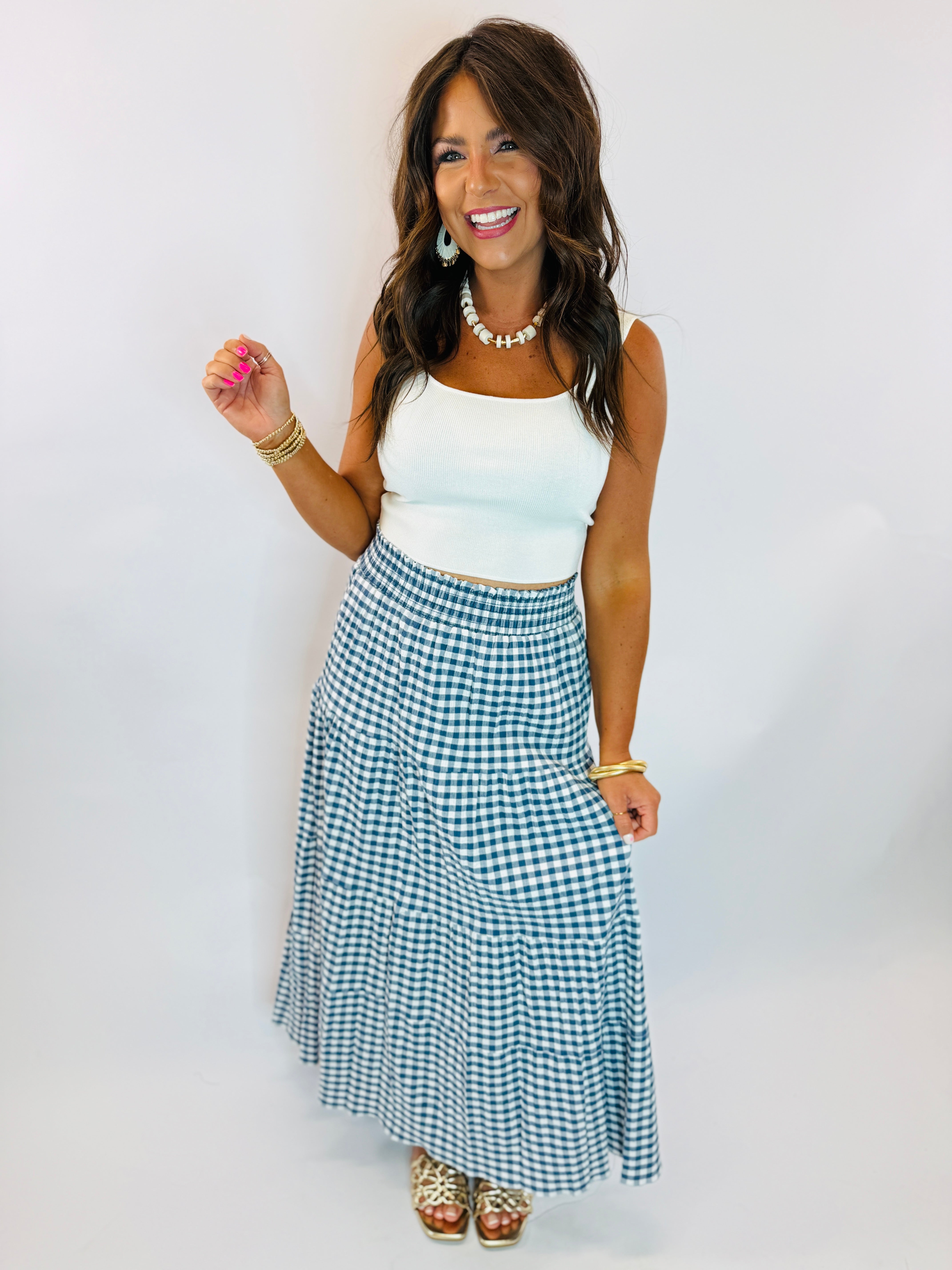 Navy and white gingham tiered maxi skirt with smocked waist, styled with white crop top.