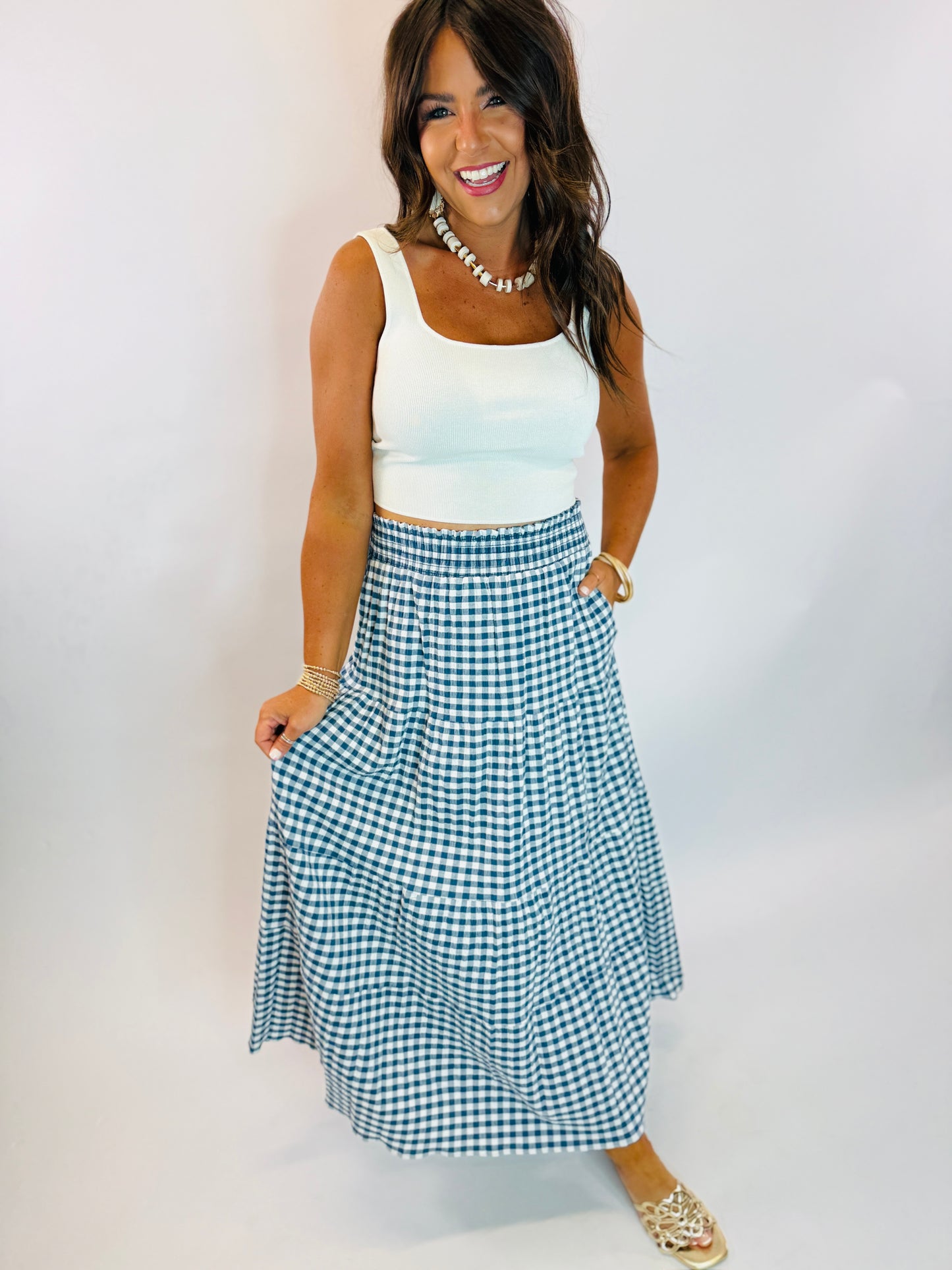 Navy and white gingham tiered maxi skirt with smocked waistband, styled with white crop tank top.