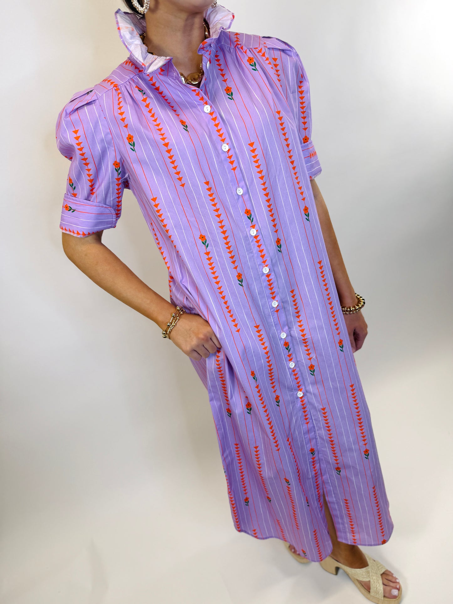 Purple striped shirt dress with red floral embroidery, white buttons, and ruffled collar in extended sizing.