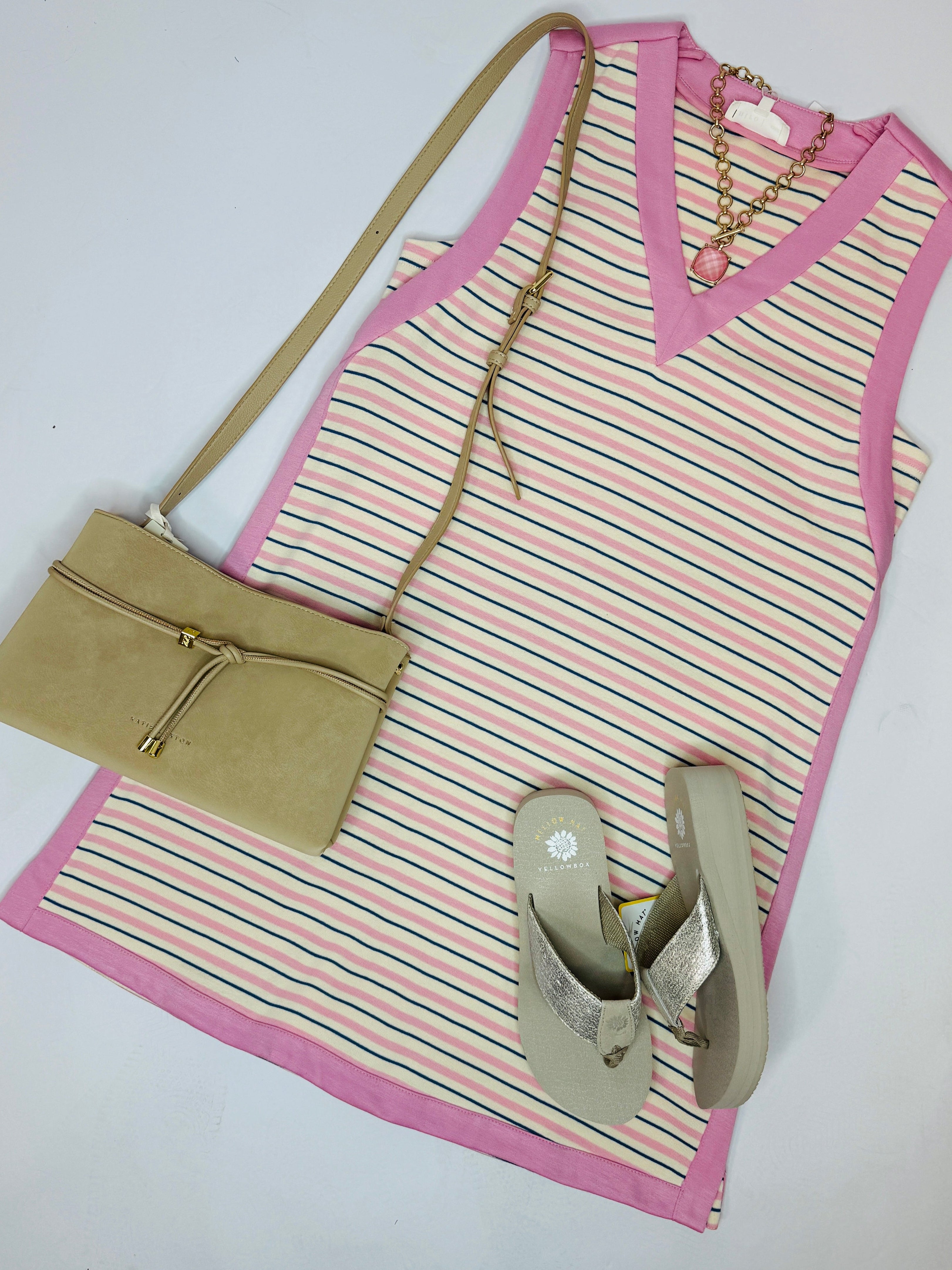 Pink striped sleeveless Darcy dress styled with beige crossbody bag, sandals, and gold chain necklace on white background.