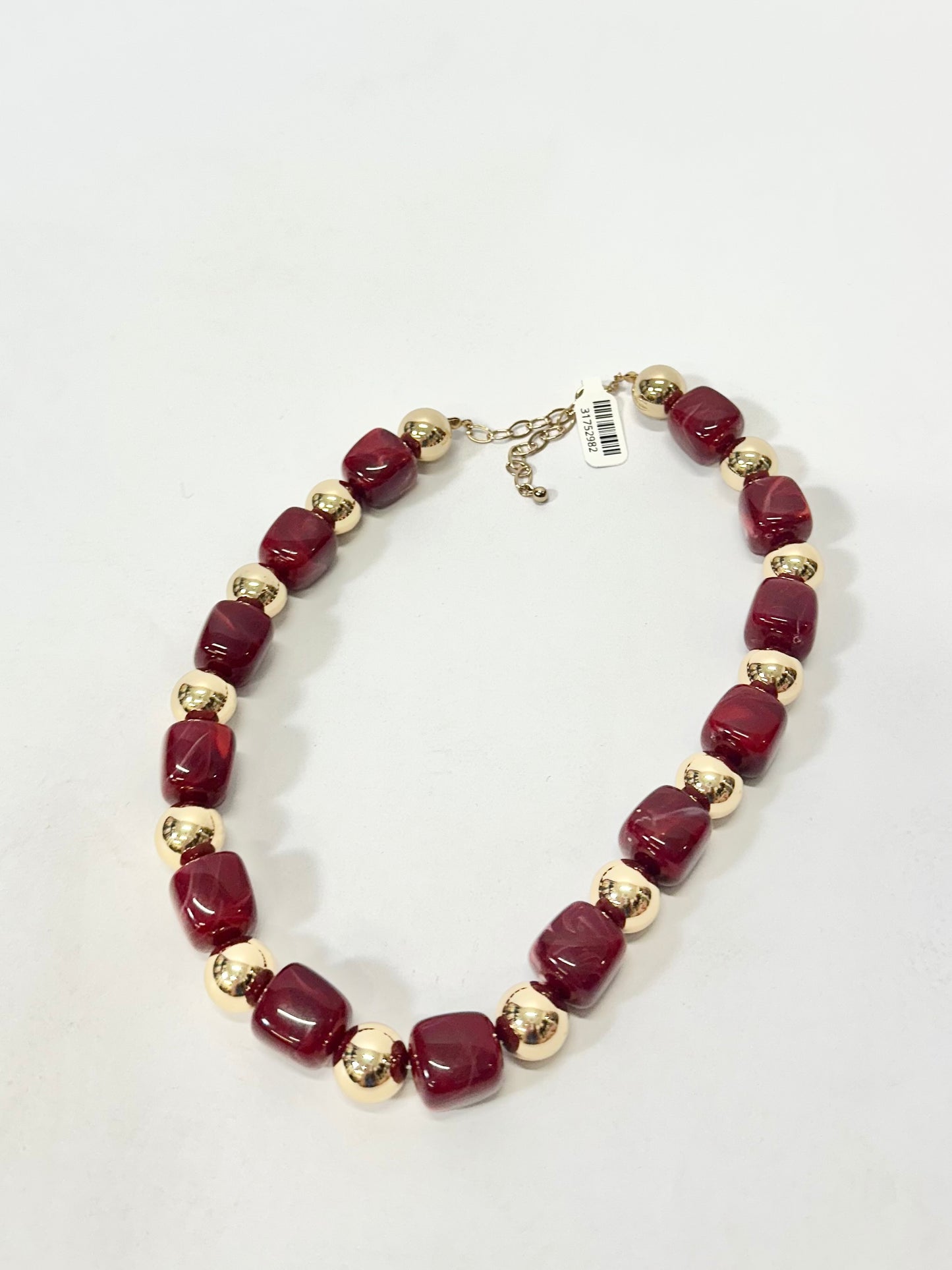 Beaded necklace alternating maroon chunky square beads and gold metallic round beads with extender chain.