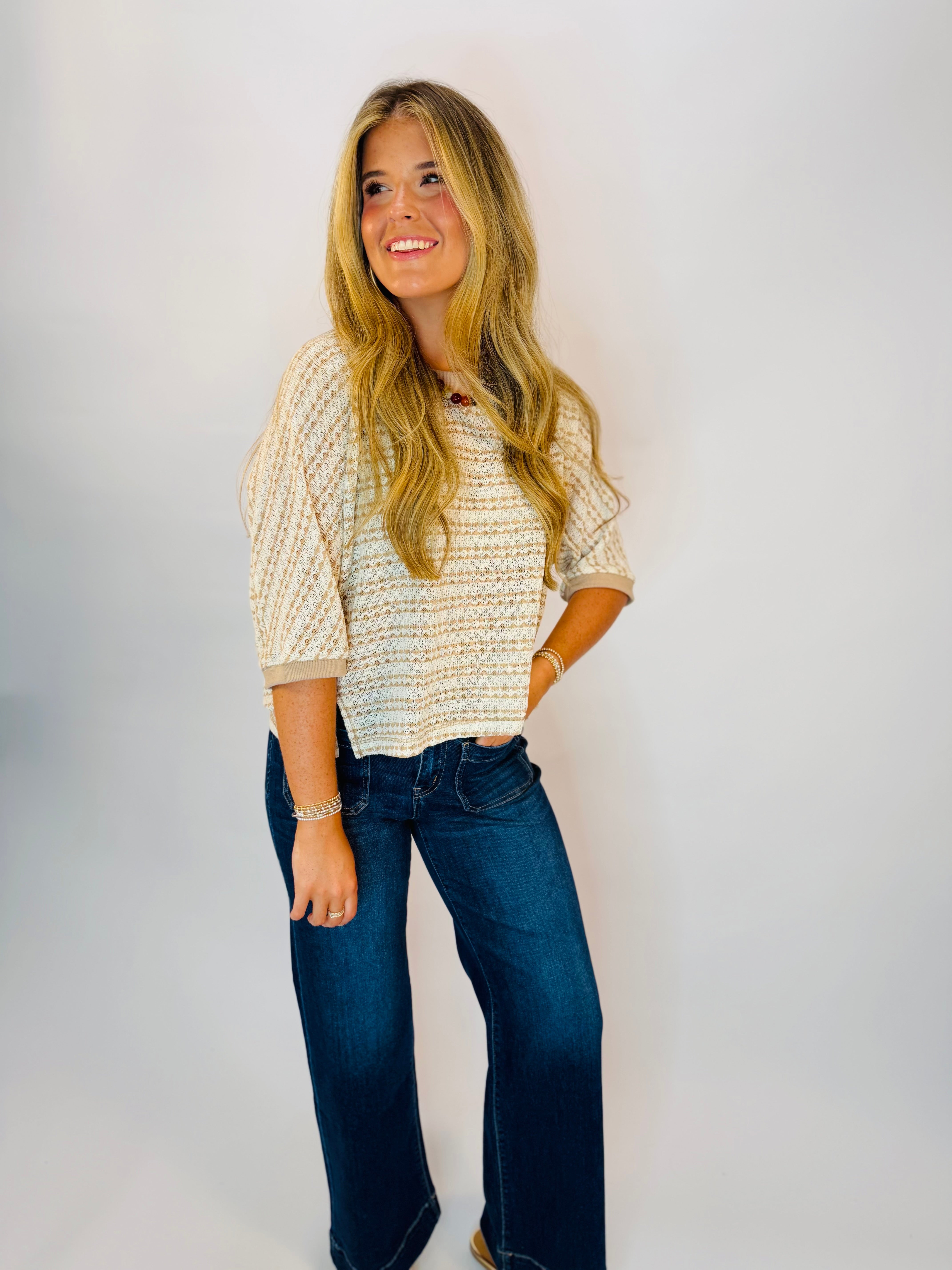 Natalie Top in Mocha — cream and tan striped knit short-sleeve top paired with dark wide-leg jeans.