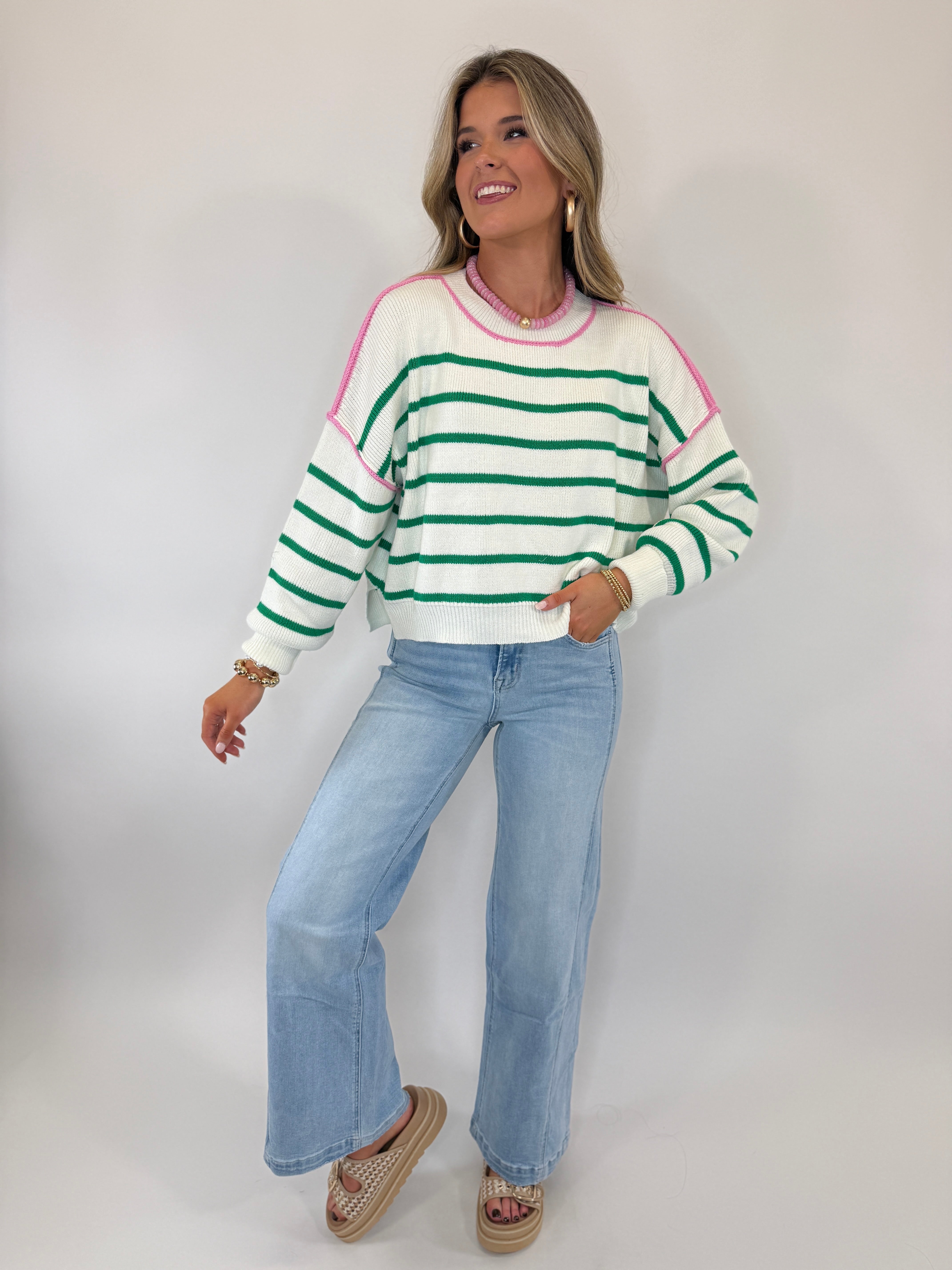 Woman wearing striped sweater and light blue structured wide-leg denim jeans with platform sandals