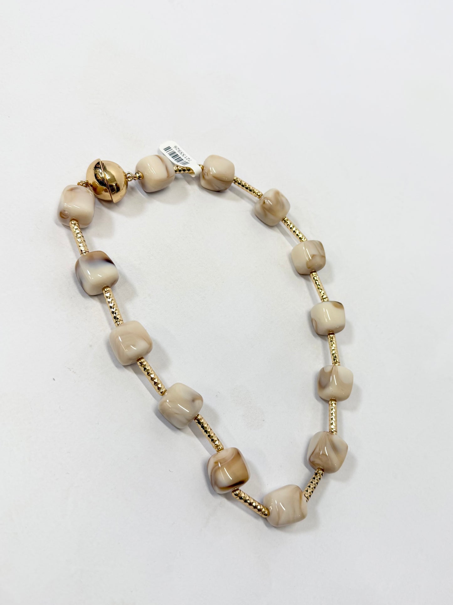 Beaded necklace featuring cream marbled cube beads alternating with textured gold bar spacers and gold magnetic clasp.
