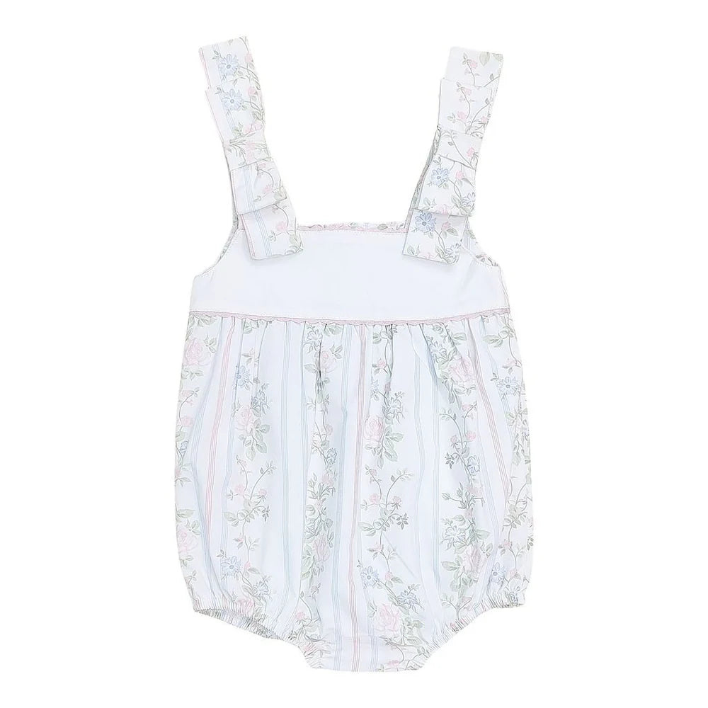 Baby bubble romper with blue and pink floral print, bow shoulder straps, and elastic leg openings