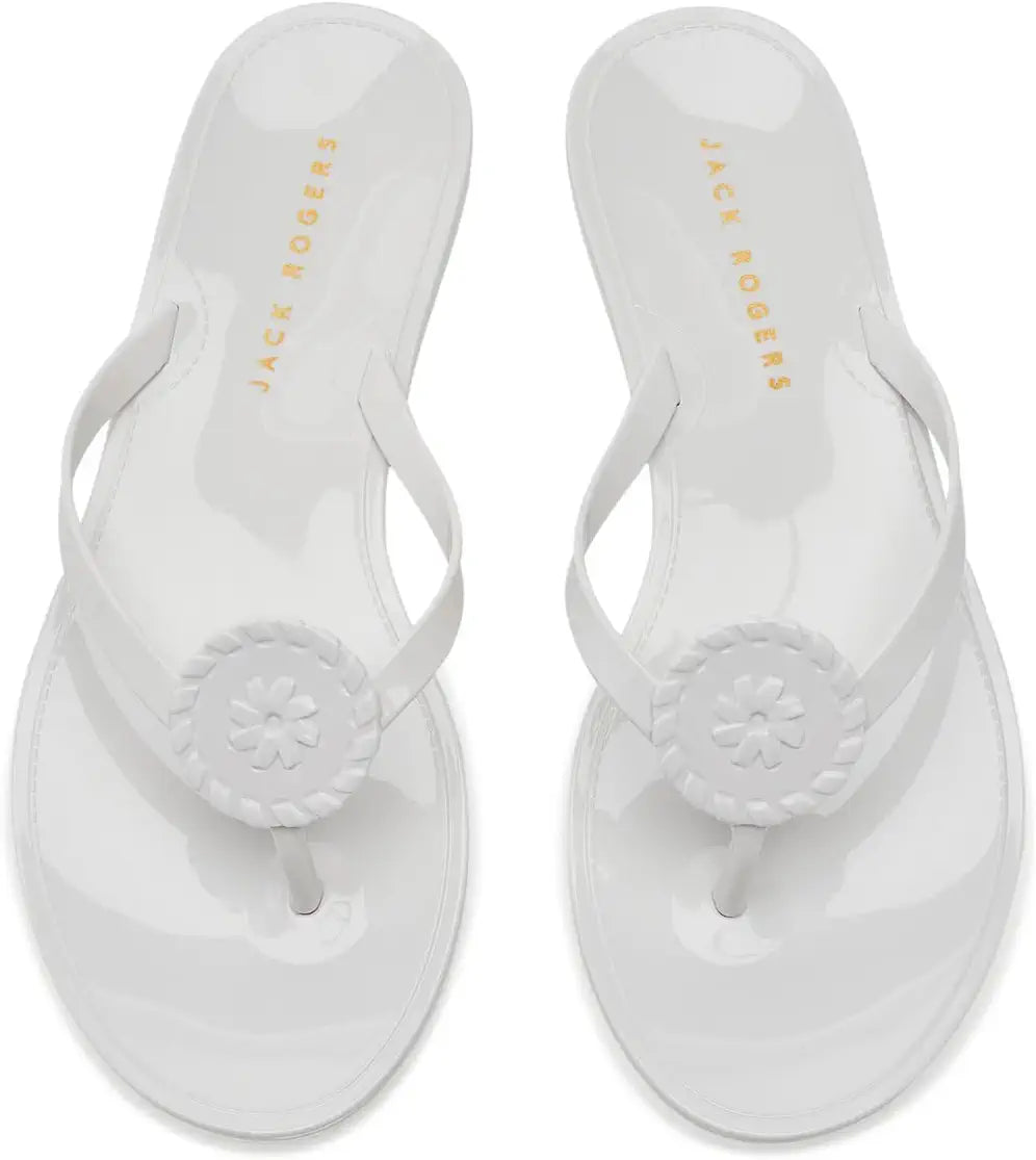 Jack Rogers Roxy Jelly white rubber thong sandals with circular medallion toe detail, top view.