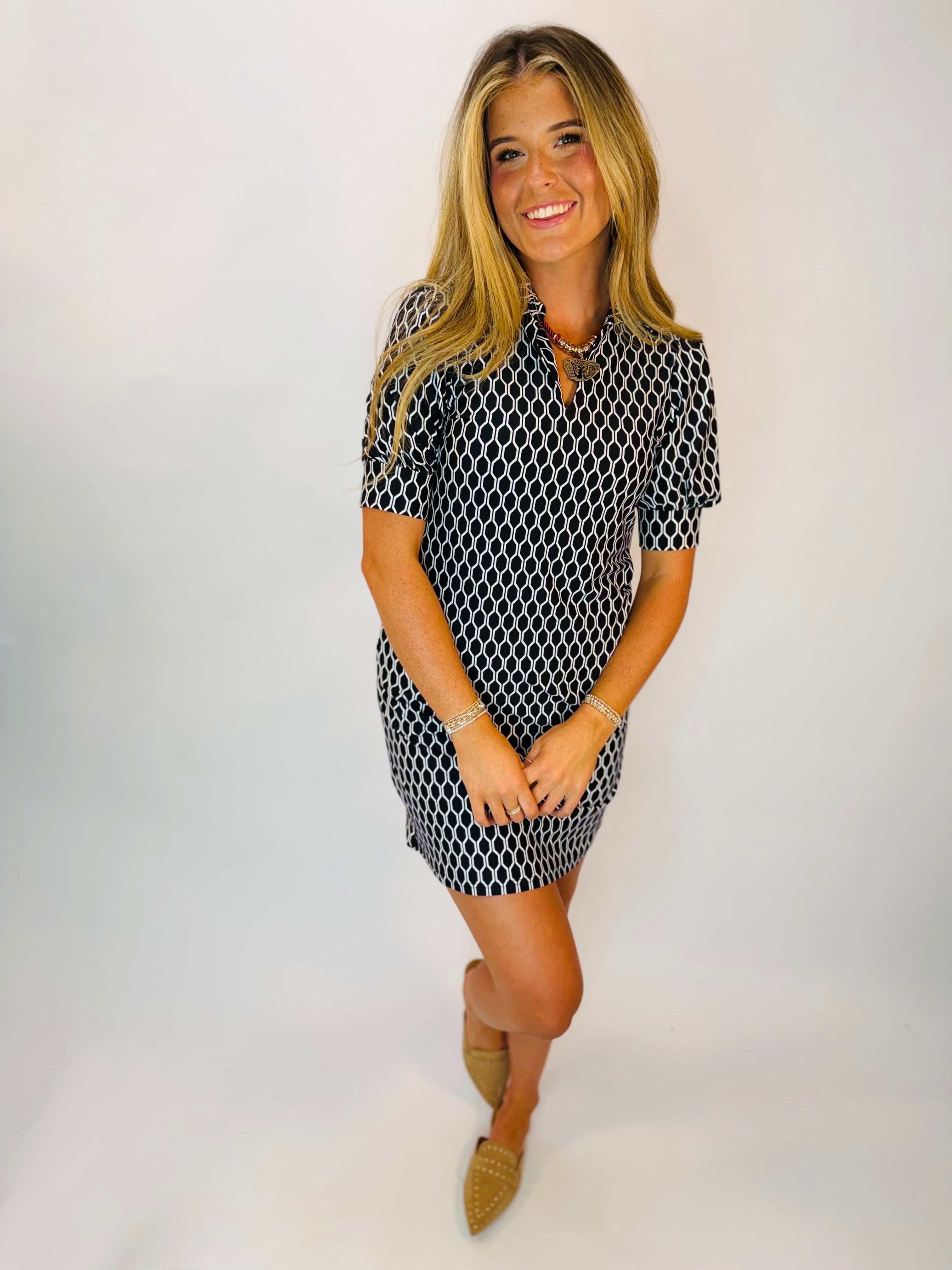 Georgie Dress in black and white honeycomb print, short sleeves, mini length, worn with tan mules.