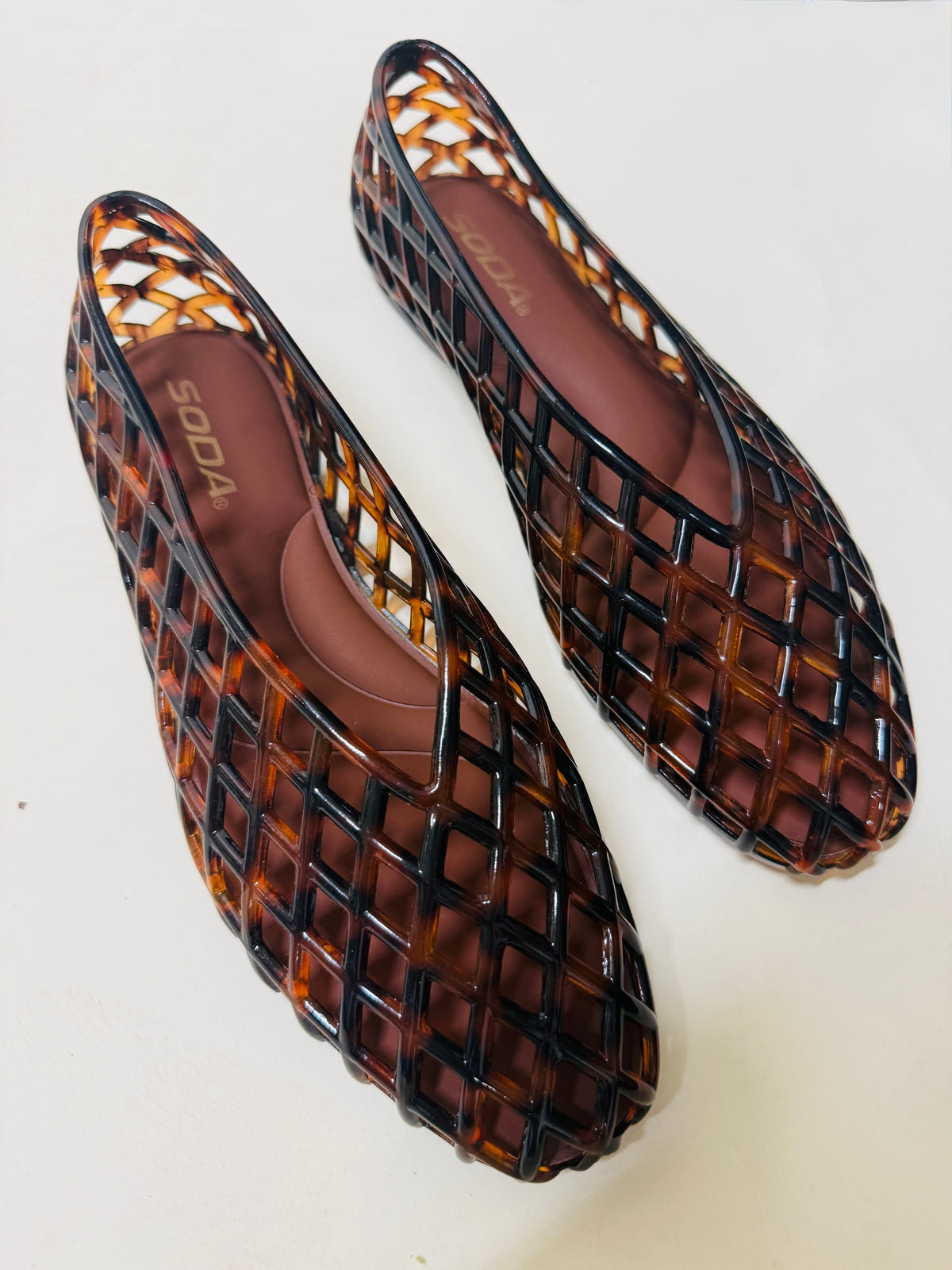 Soda brand Taylor Jelly Flat shoes in tortoiseshell brown with open lattice cage design, flat sole.