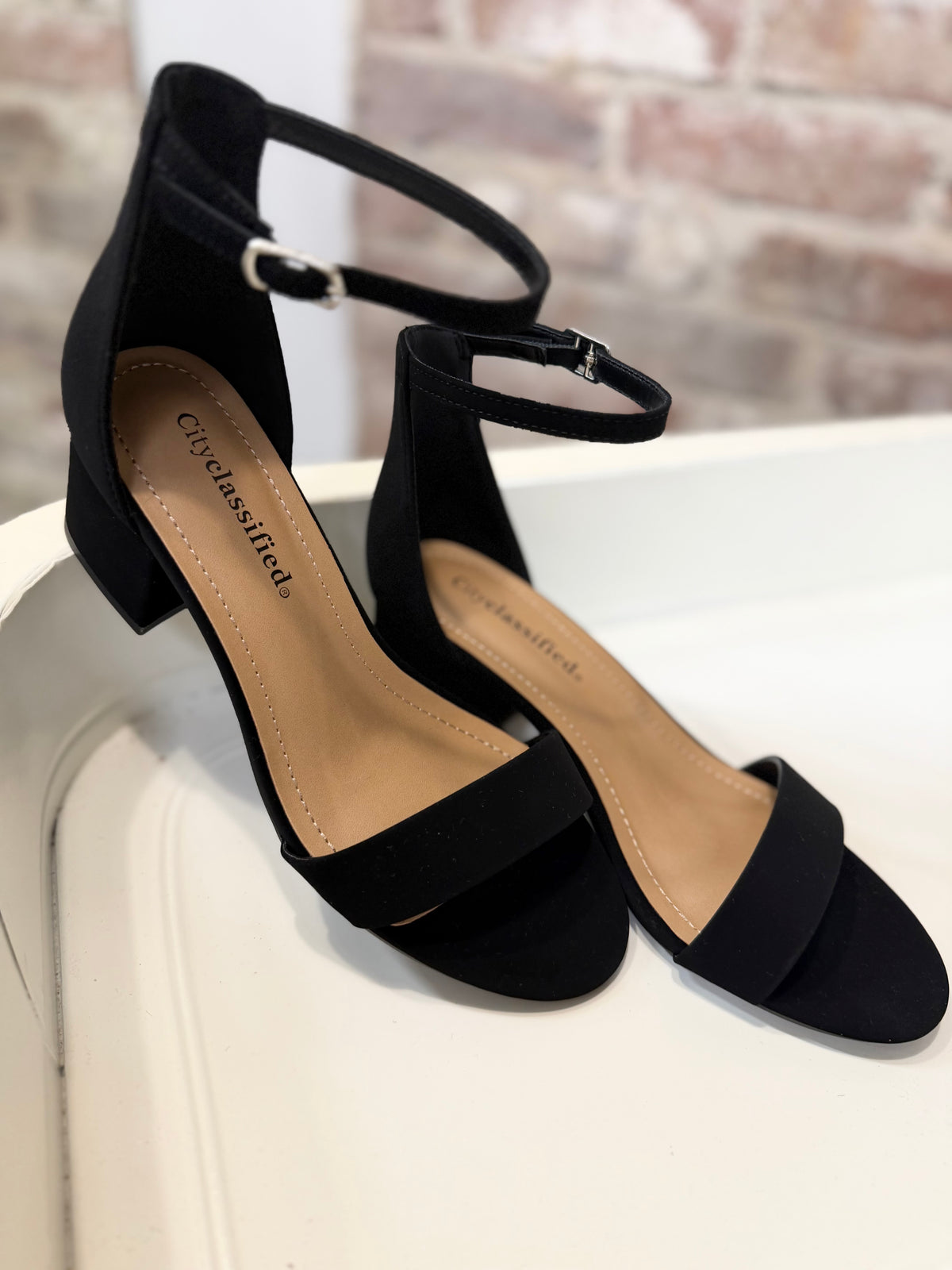 City Classified Jessica black suede block heel sandals with ankle strap and silver buckle closure.