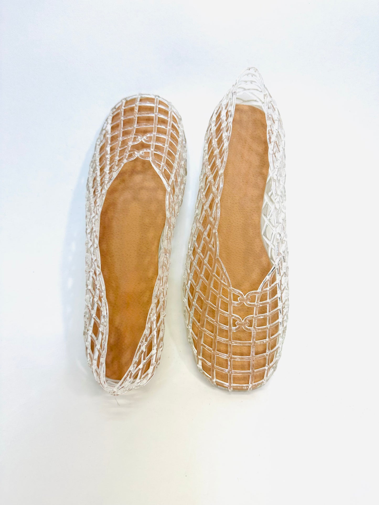 White woven mesh flat sandals with tan leather insoles, displayed from above on white background.