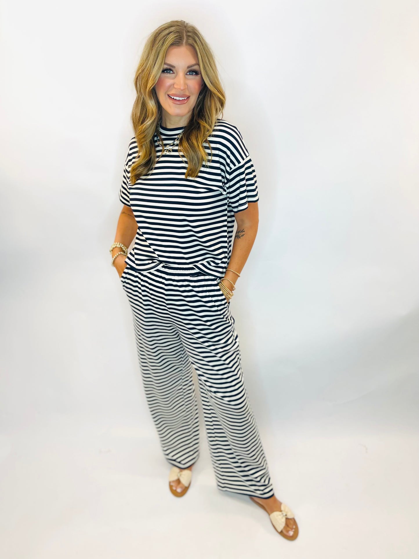Navy and white horizontal striped short-sleeve top styled with matching wide-leg pants and sandals.