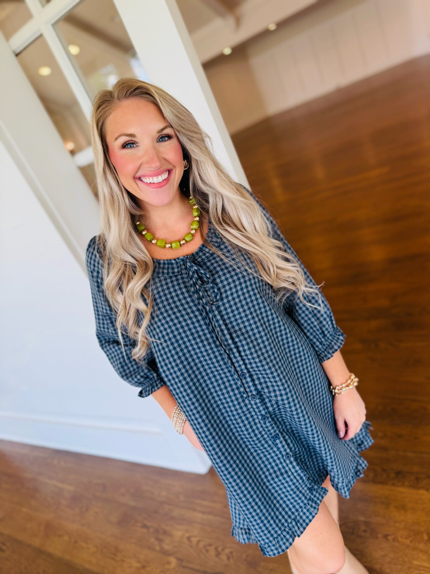 Angled view of Lorin wearing the Daphne navy and mint printed dress