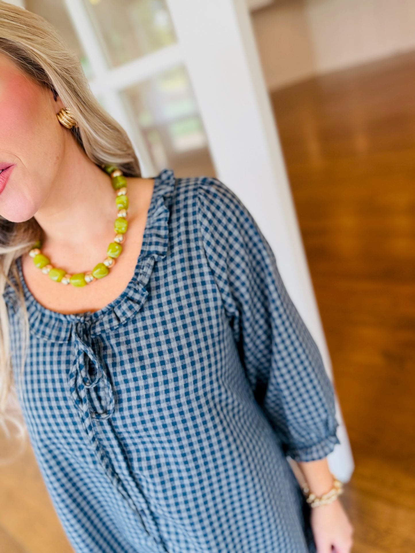 Close-up of the Daphne dress neckline and navy and mint print