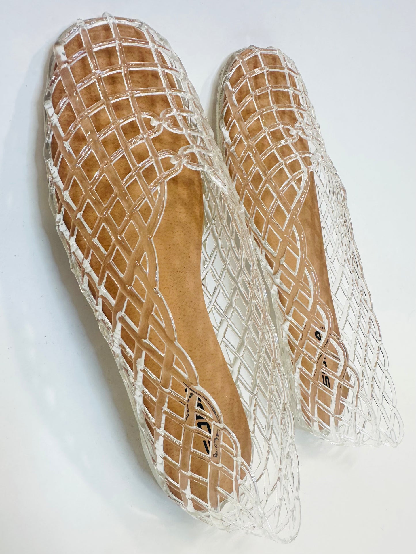 Clear jelly sandals with diamond lattice pattern and cork-colored insoles, showing top and side views.