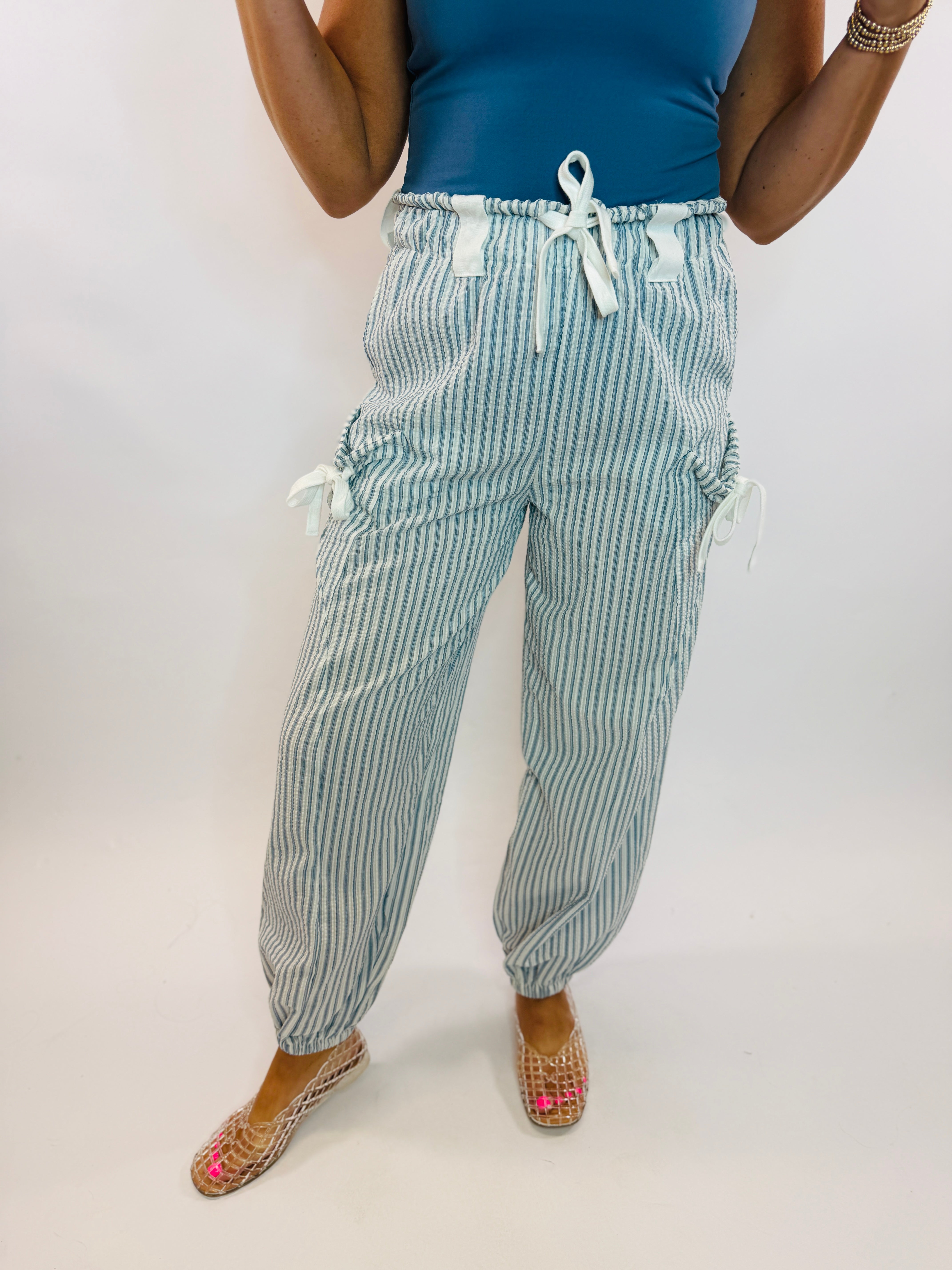 Sally Pant in blue and white vertical stripes with drawstring waist and side tie cargo pockets.