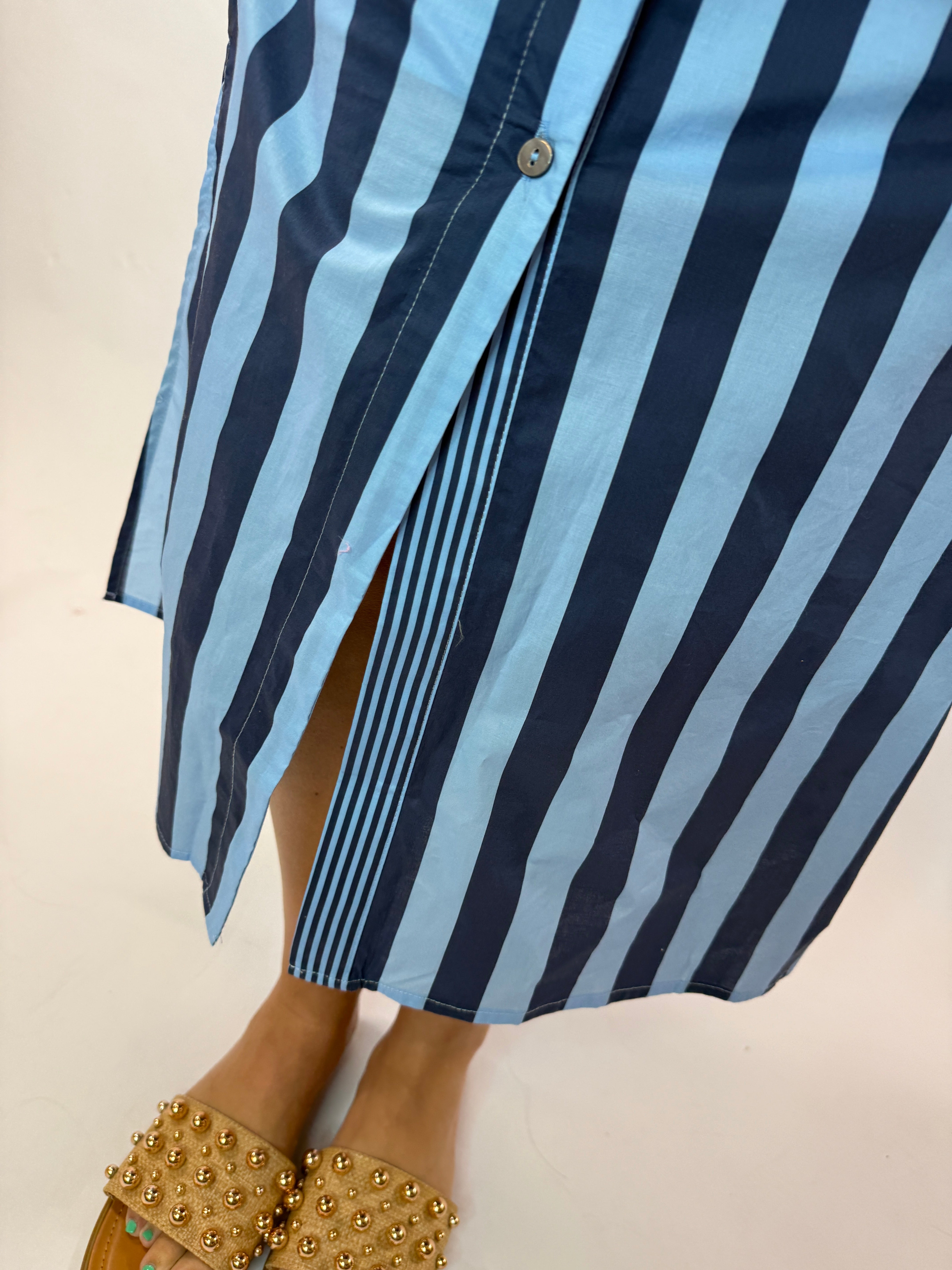 Blue and navy striped Dora Maxi dress with button detail, worn with gold studded sandals.