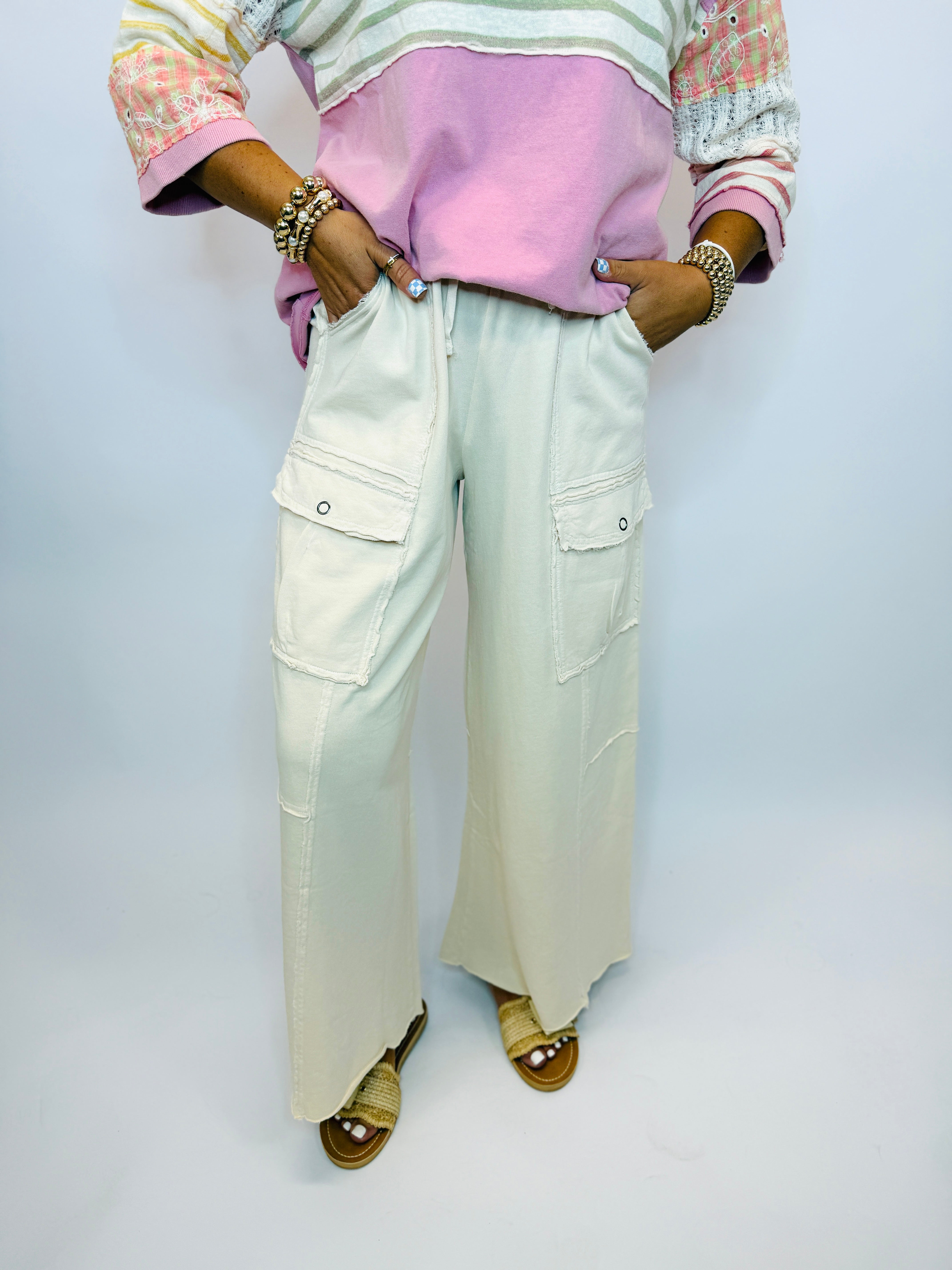 Wide-leg cargo pants in light mint green with multiple pockets and drawstring waist.
