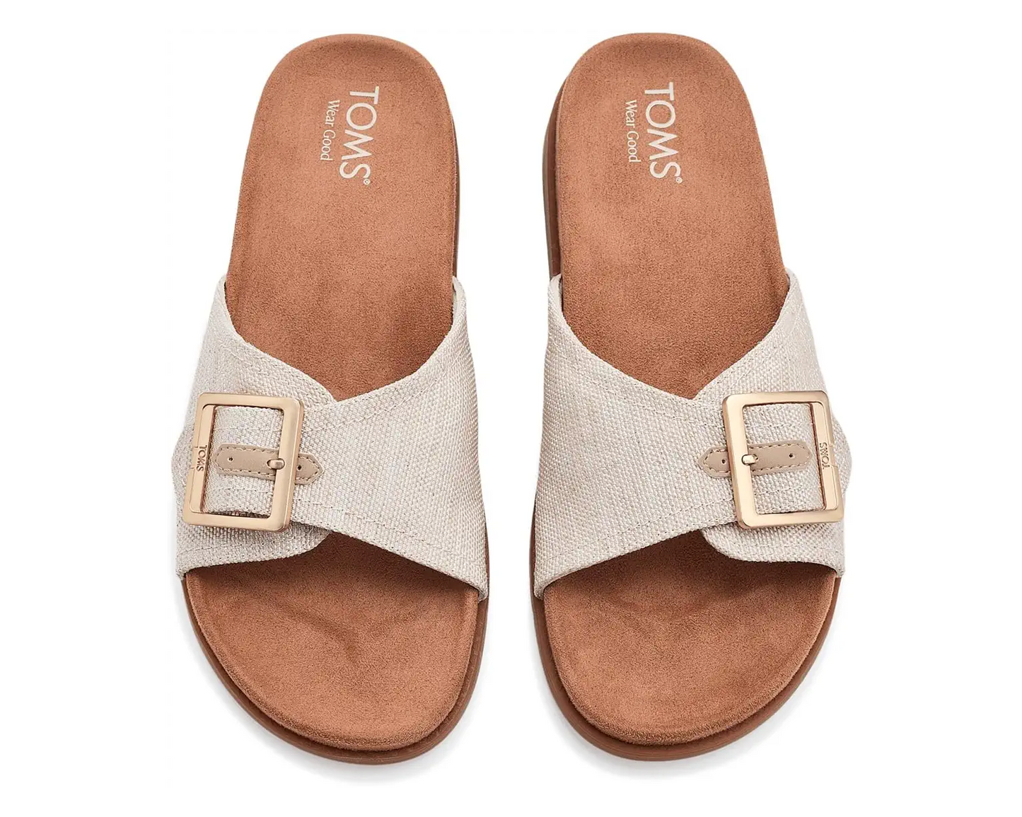 TOMS Marin natural canvas slide sandals with crossed straps, gold buckles, and brown cork footbed.