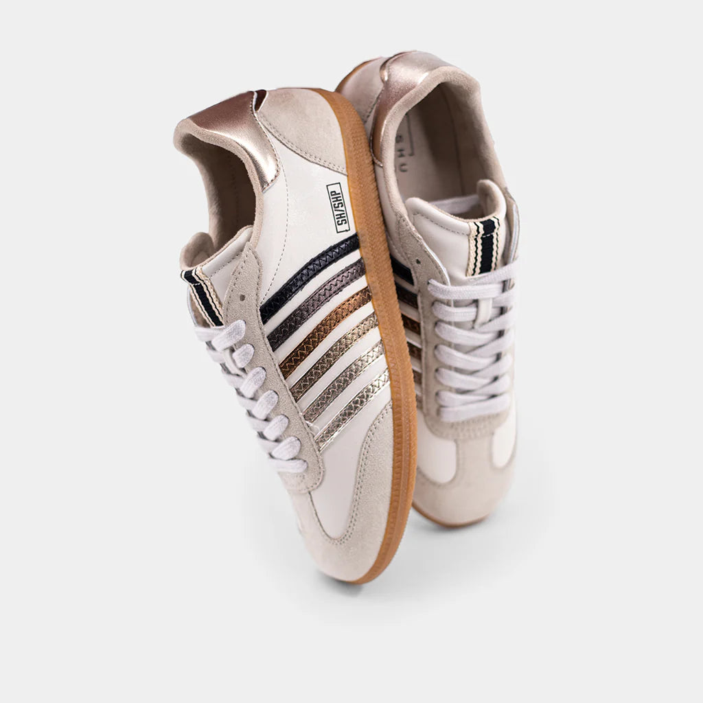 Beige Stevie Classic sneakers with metallic stripes, white laces, and gum sole on white background