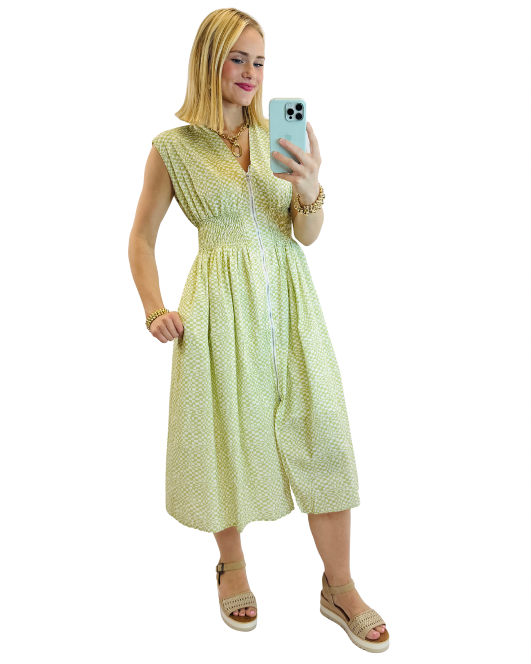 Woman wearing green patterned Monica midi dress with smocked waist and button-front closure, taking mirror selfie.