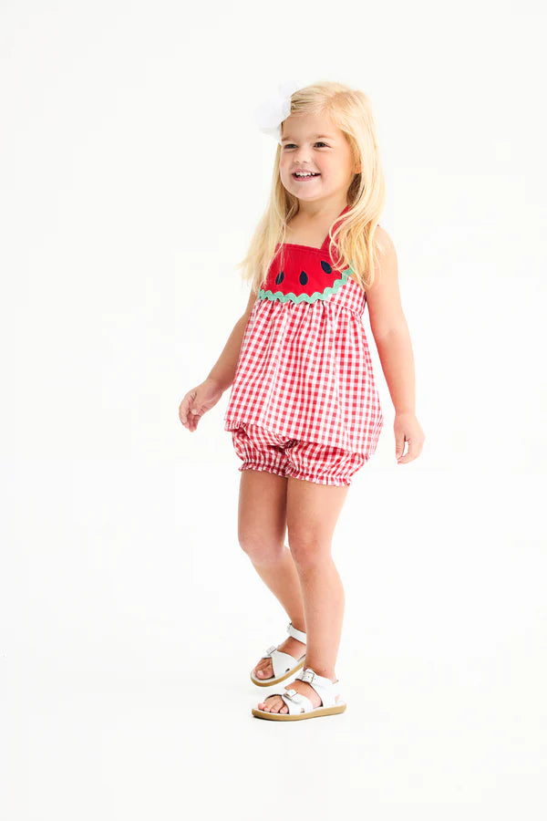 Young girl wearing red gingham two-piece outfit with watermelon applique top and matching bloomer shorts