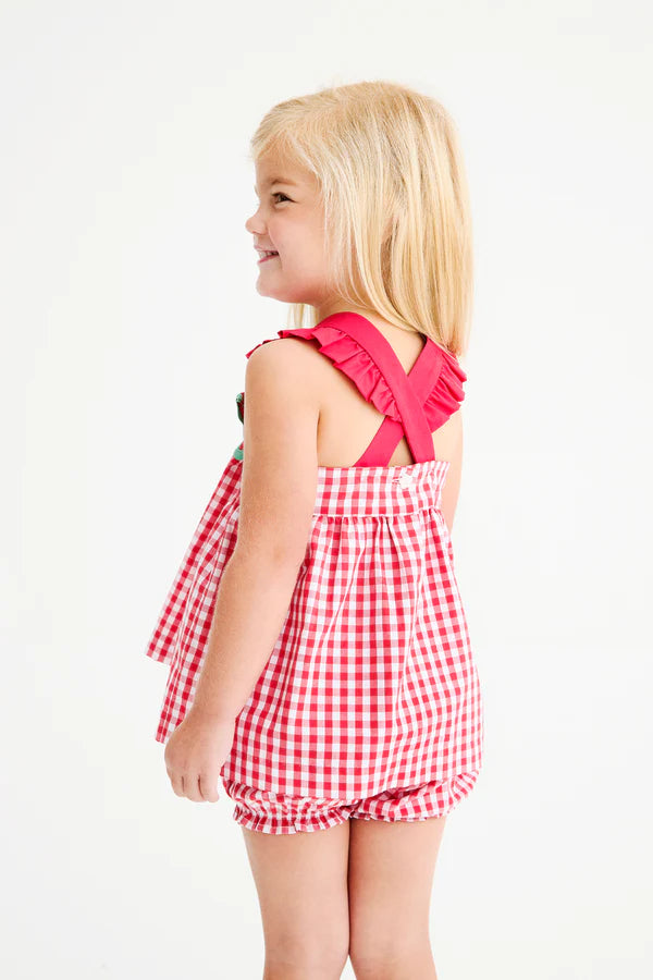 Young girl wearing red and white gingham sleeveless top with matching bloomers, featuring ruffled straps and back tie detail.