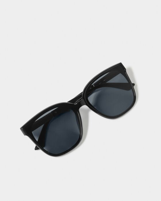 Black cat-eye sunglasses with dark tinted lenses on white background