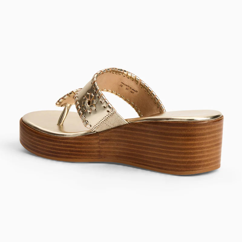 Gold leather thong sandal with decorative whipstitch detailing and stacked wooden mid-wedge heel