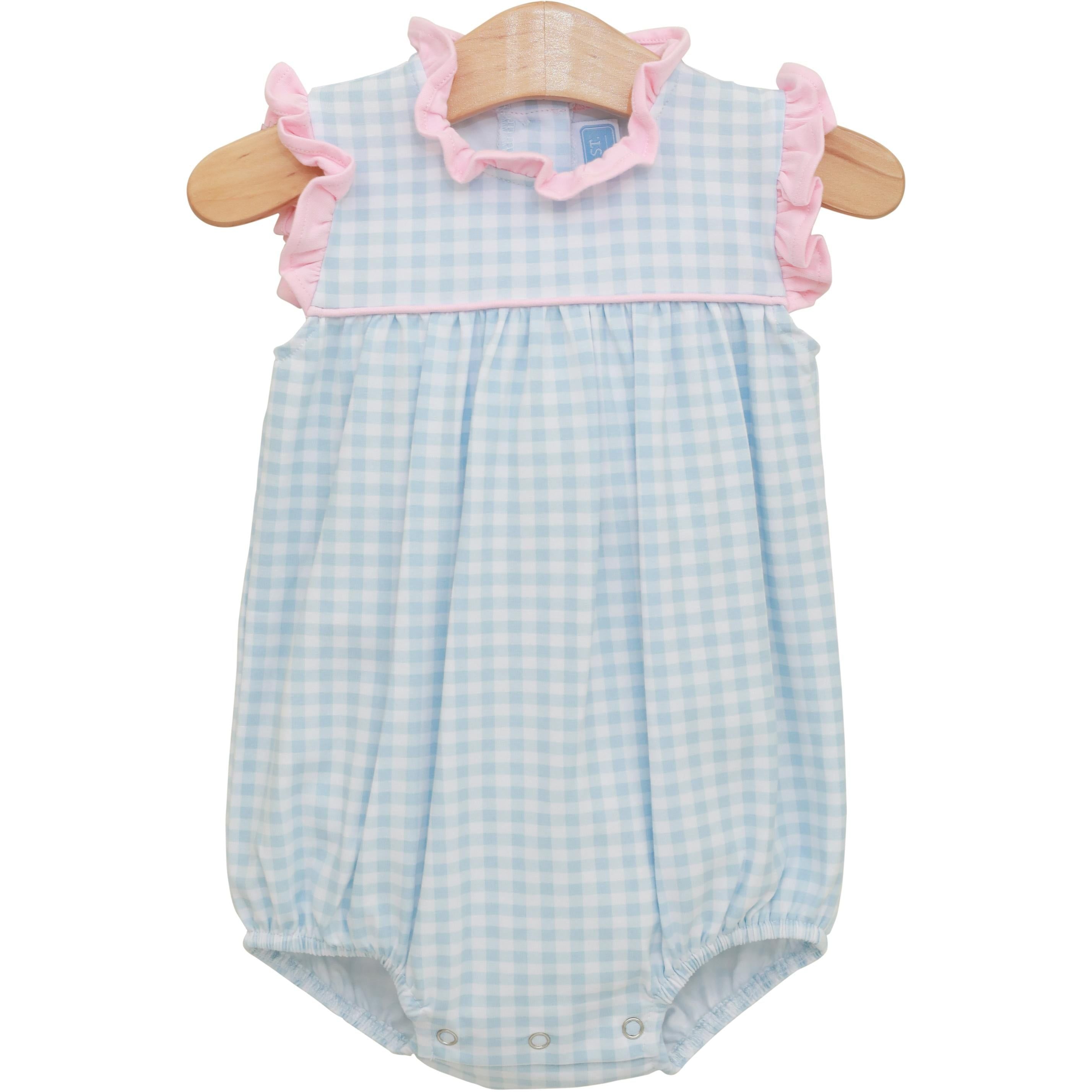 Blue and white gingham baby bubble romper with pink ruffle trim on wooden hanger
