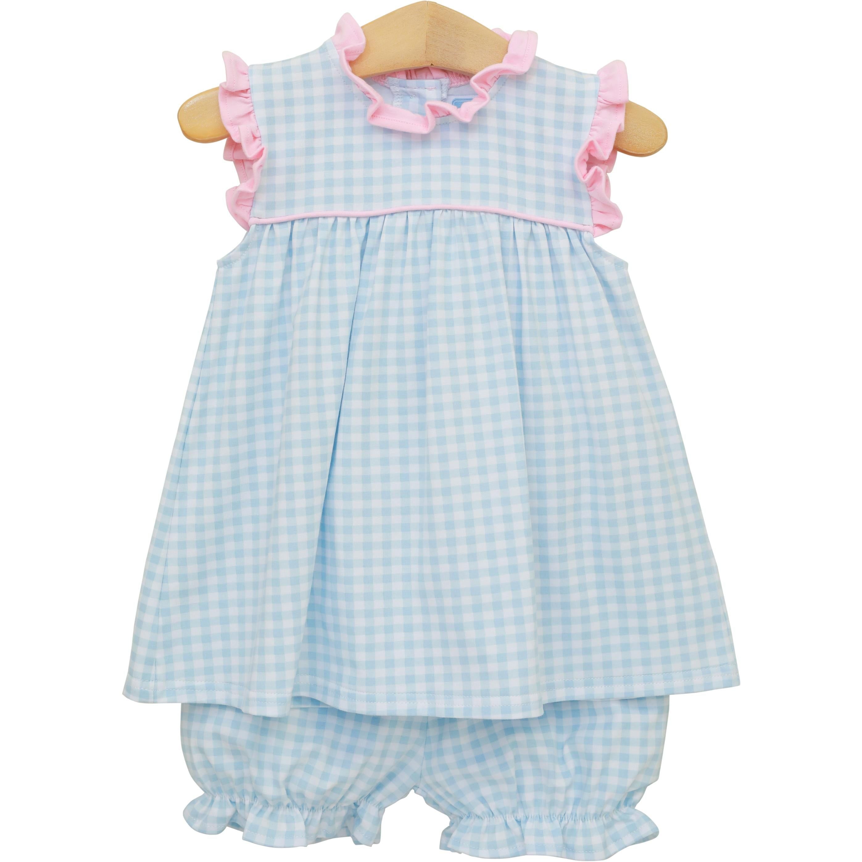 Blue and white gingham baby dress with pink ruffle trim and matching bloomers on wooden hanger