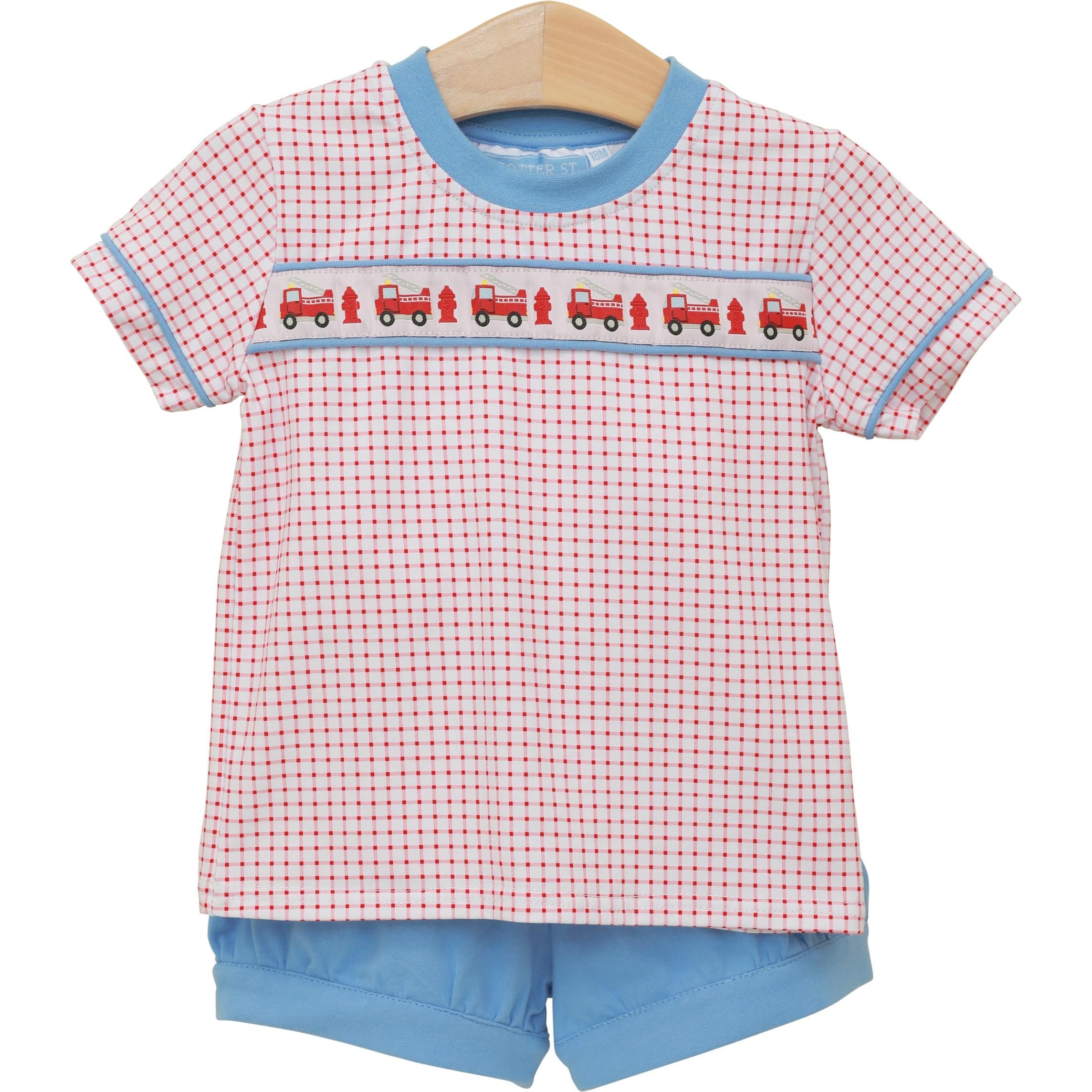 Red gingham baby short set with fire truck embroidered smocking and blue trim on wooden hanger.